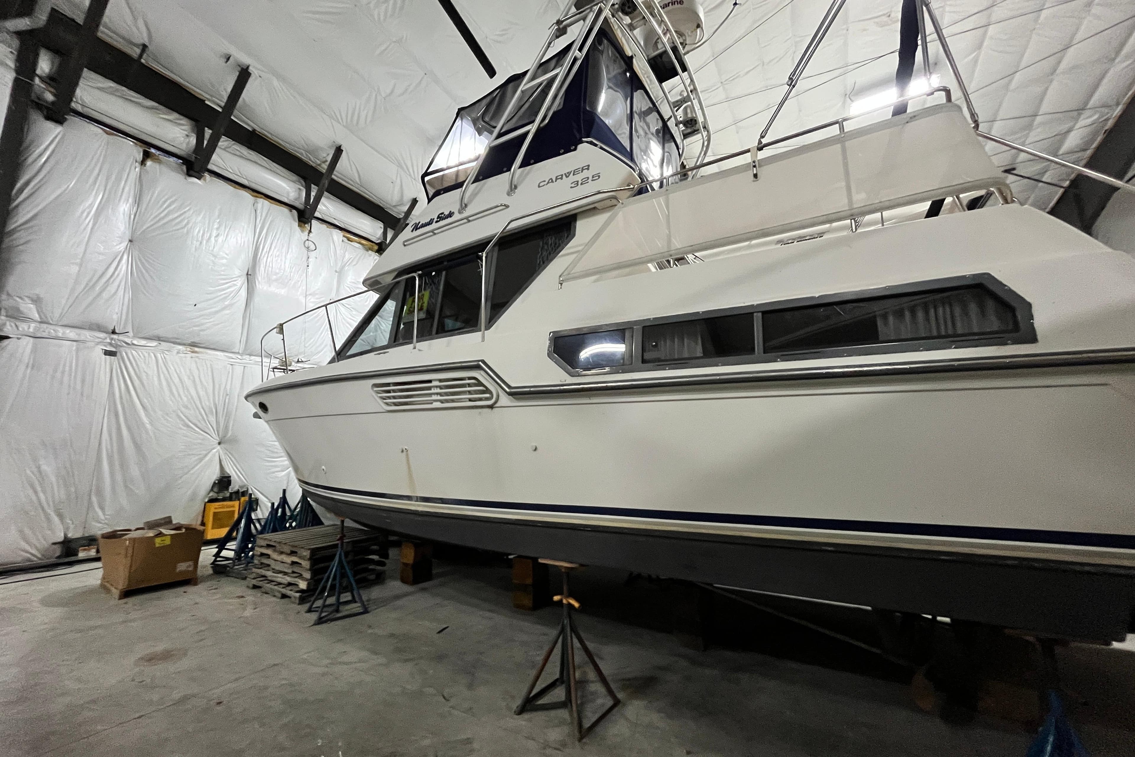 1995 Carver 325 Aft Cabin Motor Yacht in storage, side view.