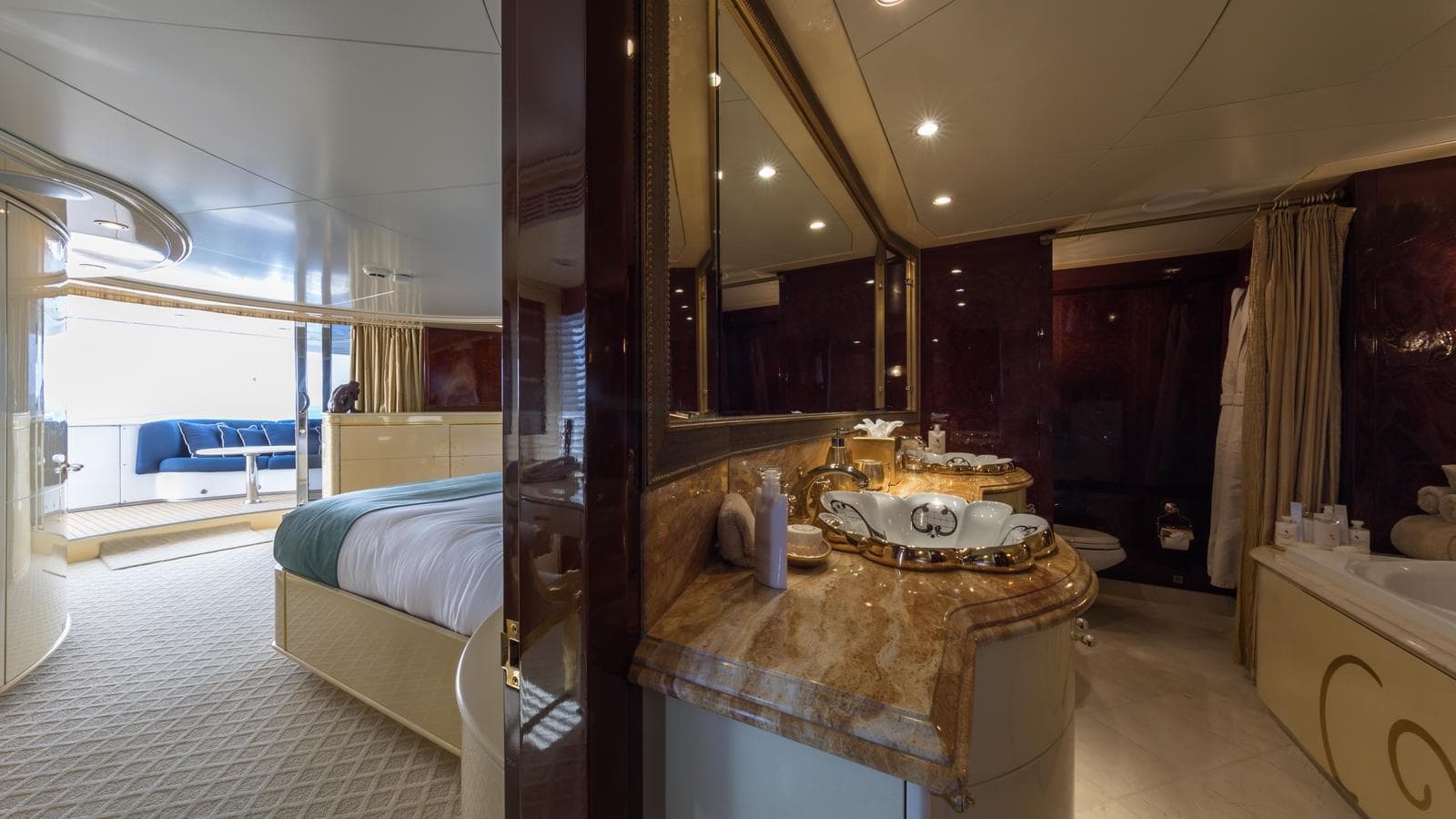 Luxurious yacht interior with elegant bedroom and marble-accented bathroom, Custom Louisbourg 2004 model.