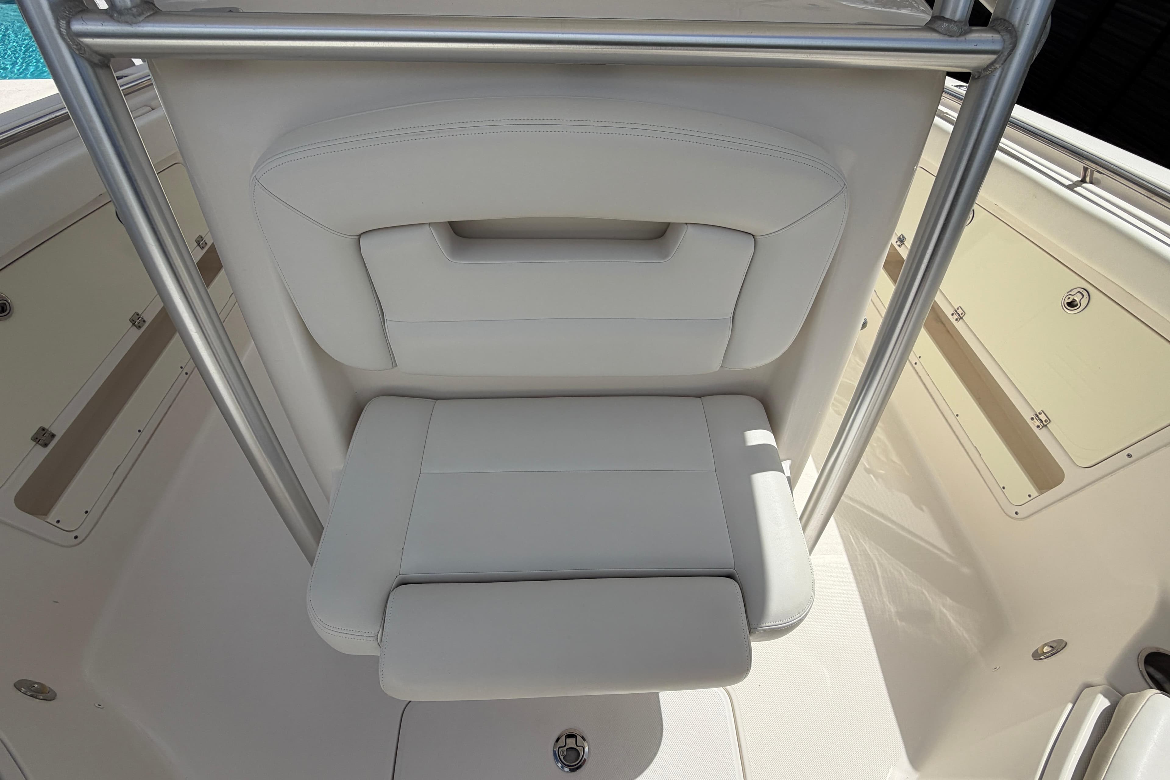 2015 Robalo R300 Center Console boat seat with white upholstery and stainless steel frame.