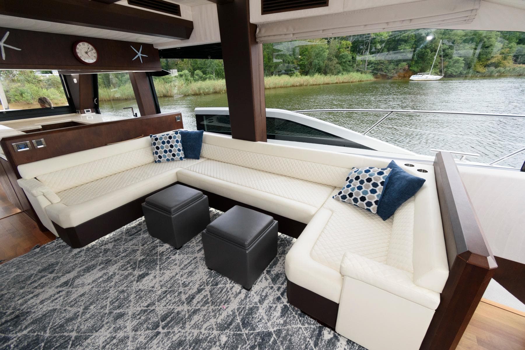 Luxurious interior of 2018 Galeon 640 Fly yacht with elegant seating and scenic water view.