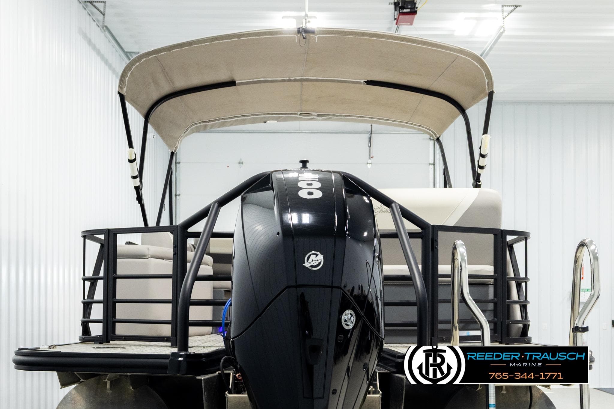 2023 SunChaser 23 Eclipse SSB pontoon boat with outboard motor in a showroom.