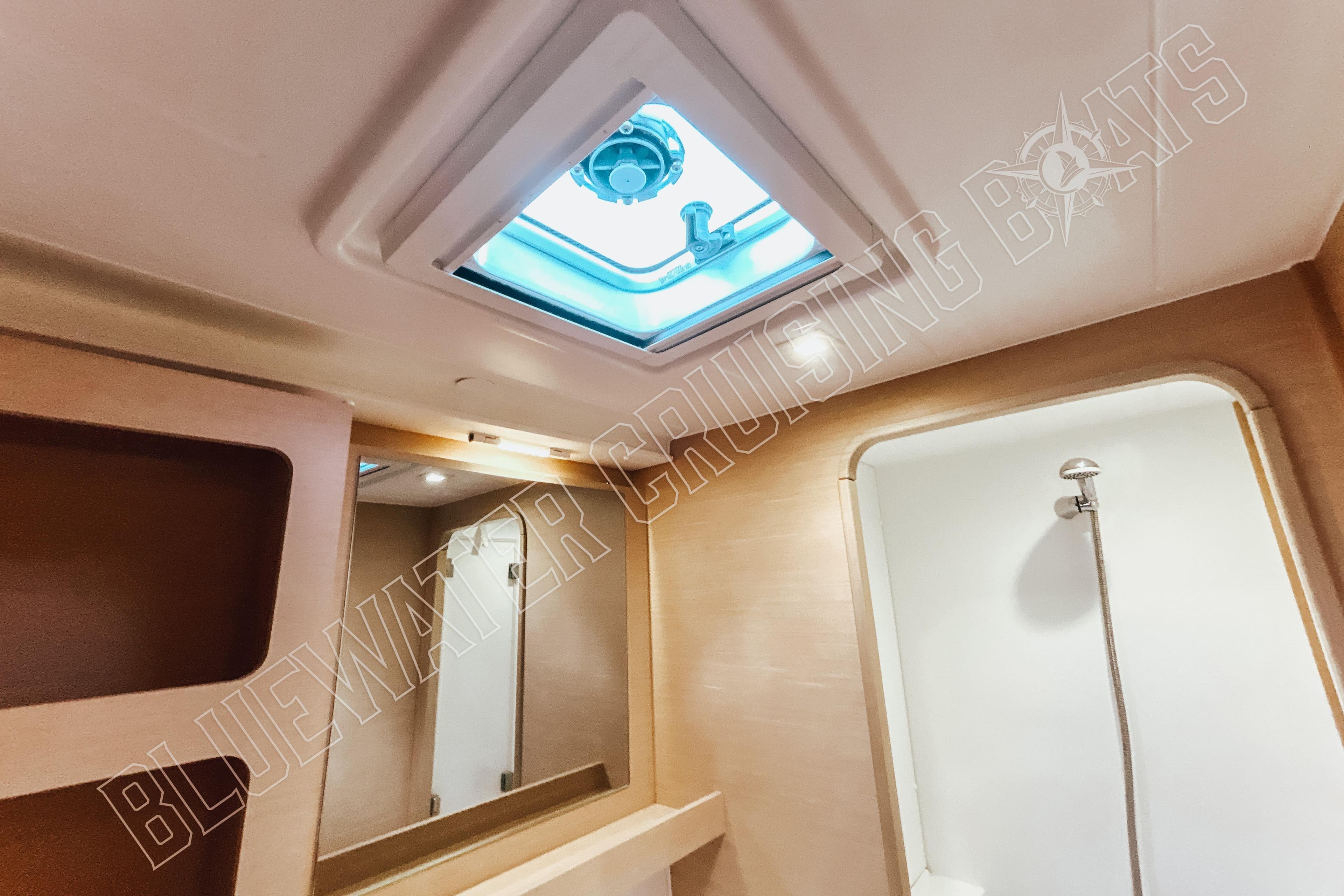 Interior of 2018 Lagoon 42 yacht bathroom with skylight and shower.