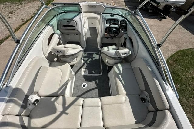 2006 Chaparral 236 SSi boat interior with white seating and steering console.