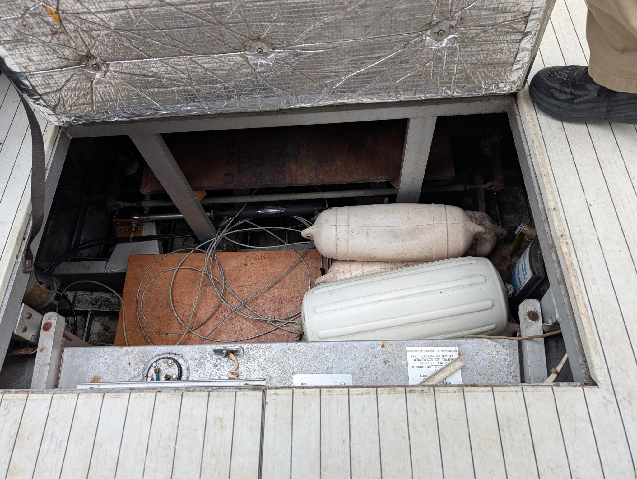 Open hatch of 1989 Marinette 28 Sport Fish Fly Bridge showing interior components and wiring.
