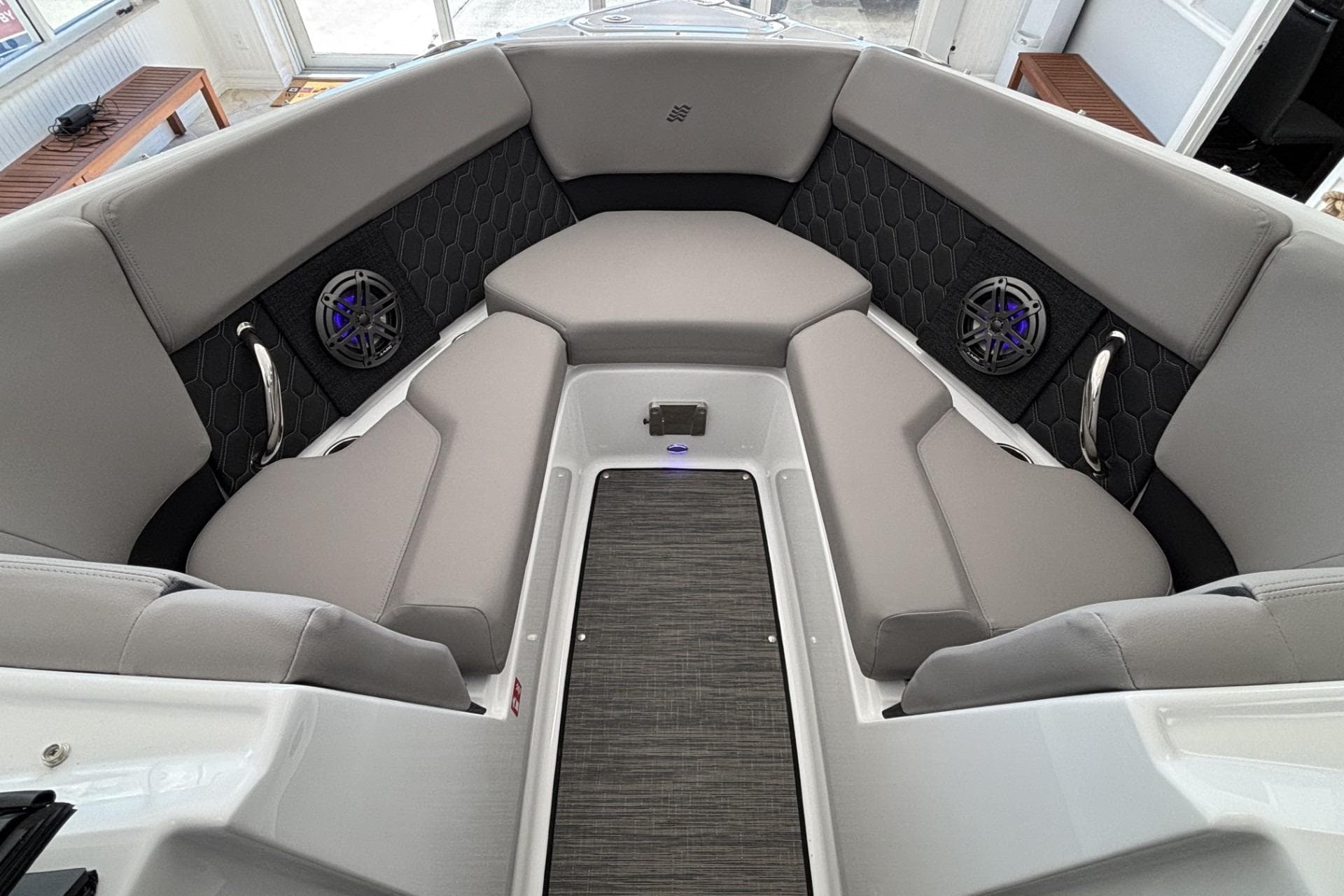 2026 Four Winns H2 boat interior with gray seating and built-in speakers.