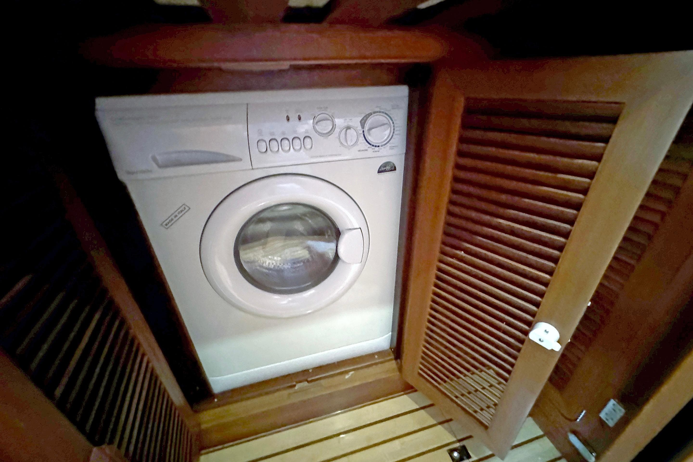 Washing machine in wooden cabinet on 2012 Hylas 49CC yacht.