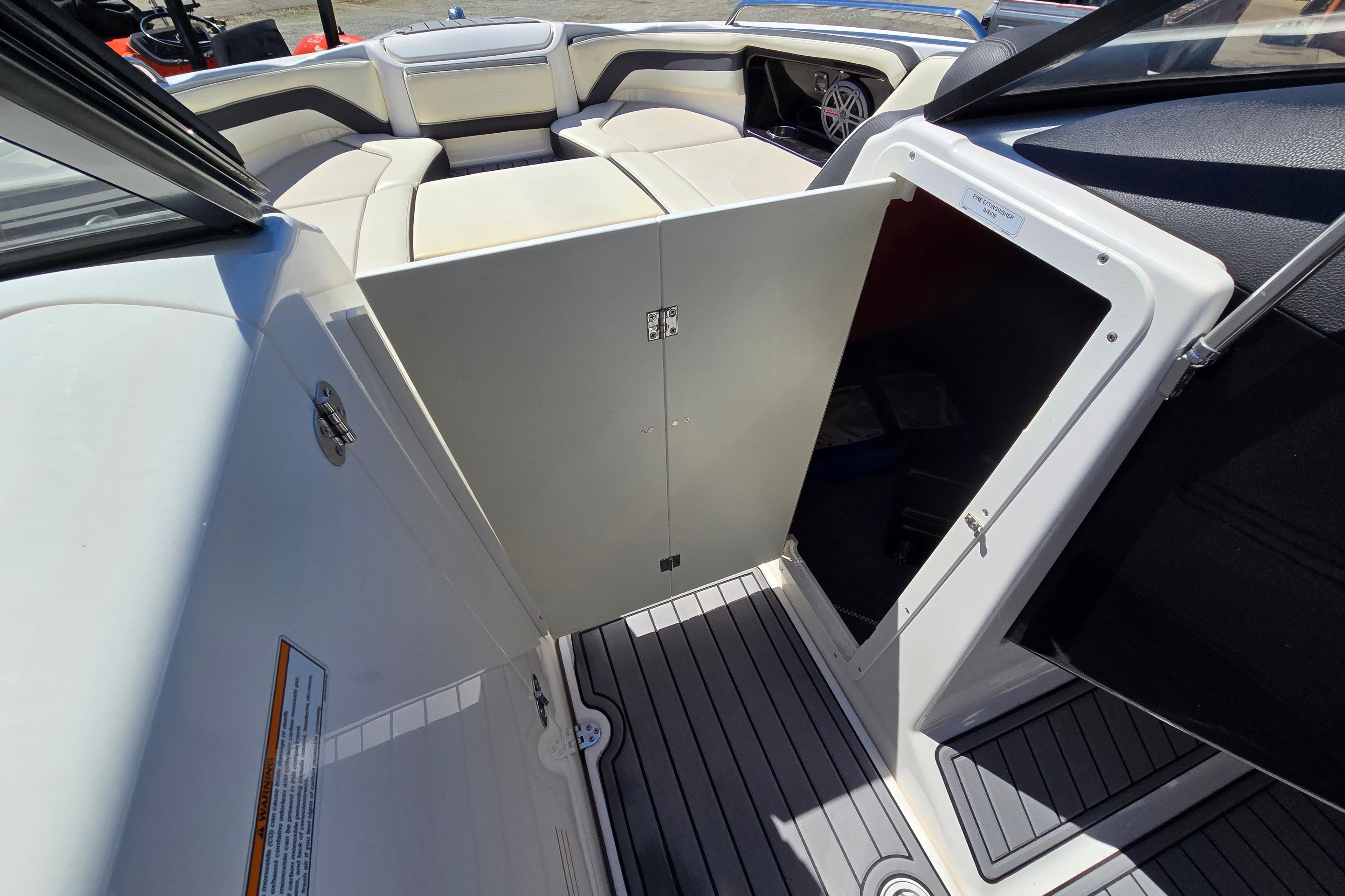 2016 Yamaha Boats 242 Limited S E-Series interior with open storage compartment.
