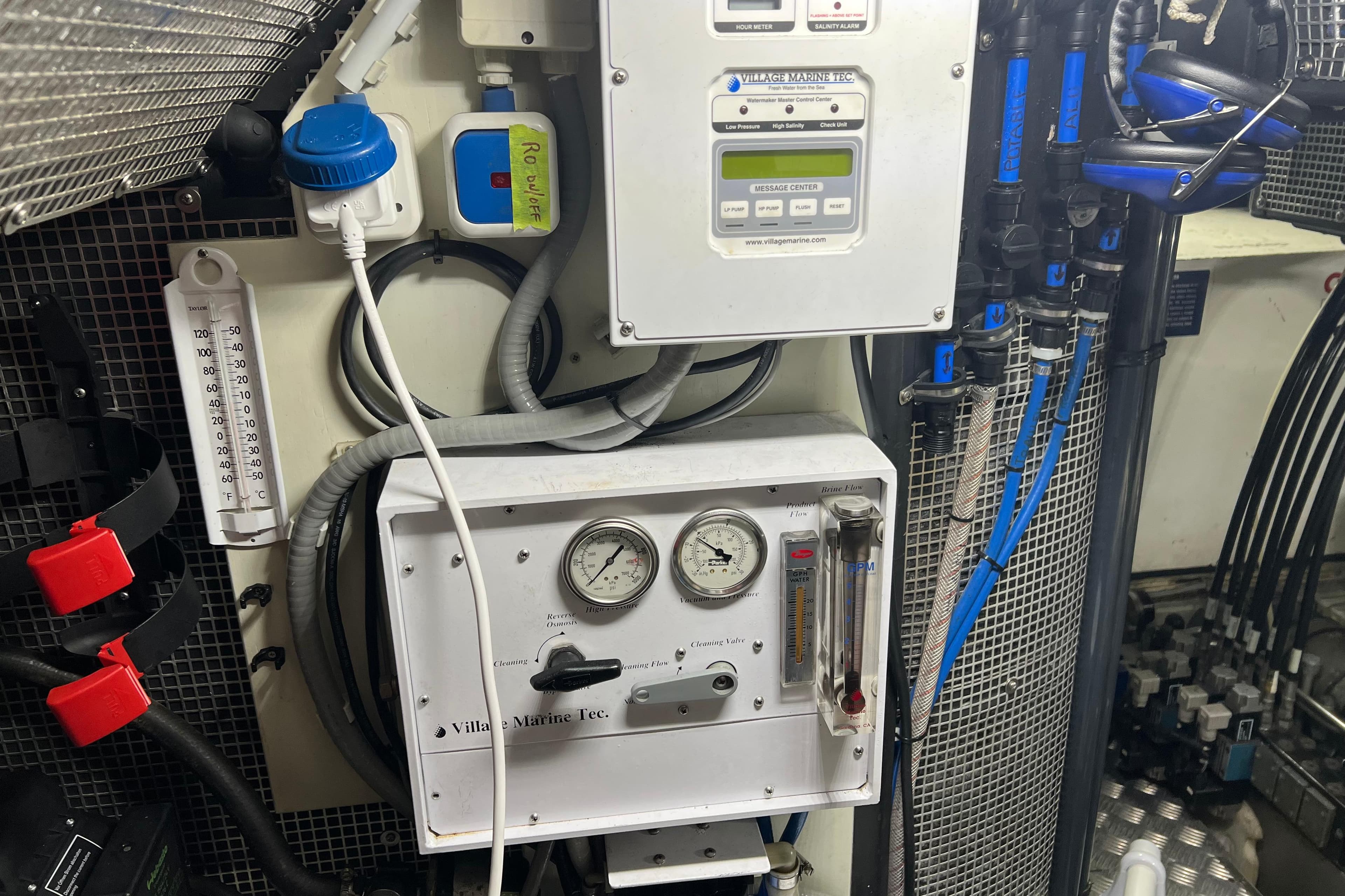 Engine room of a 1990 Trintella 49A yacht with control panels and gauges.