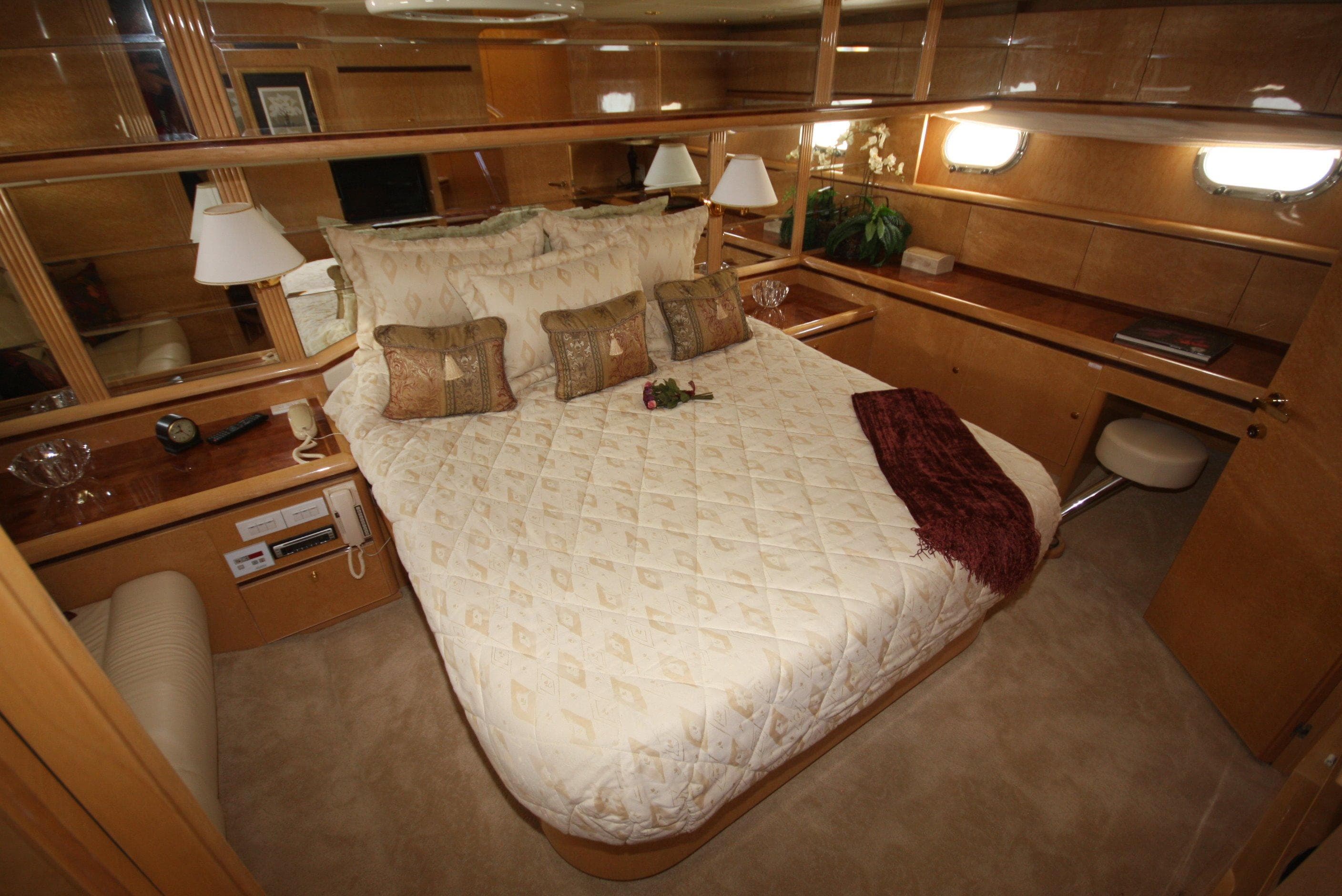 Luxurious bedroom on a 2002 Dyna 77 Laguna yacht.
