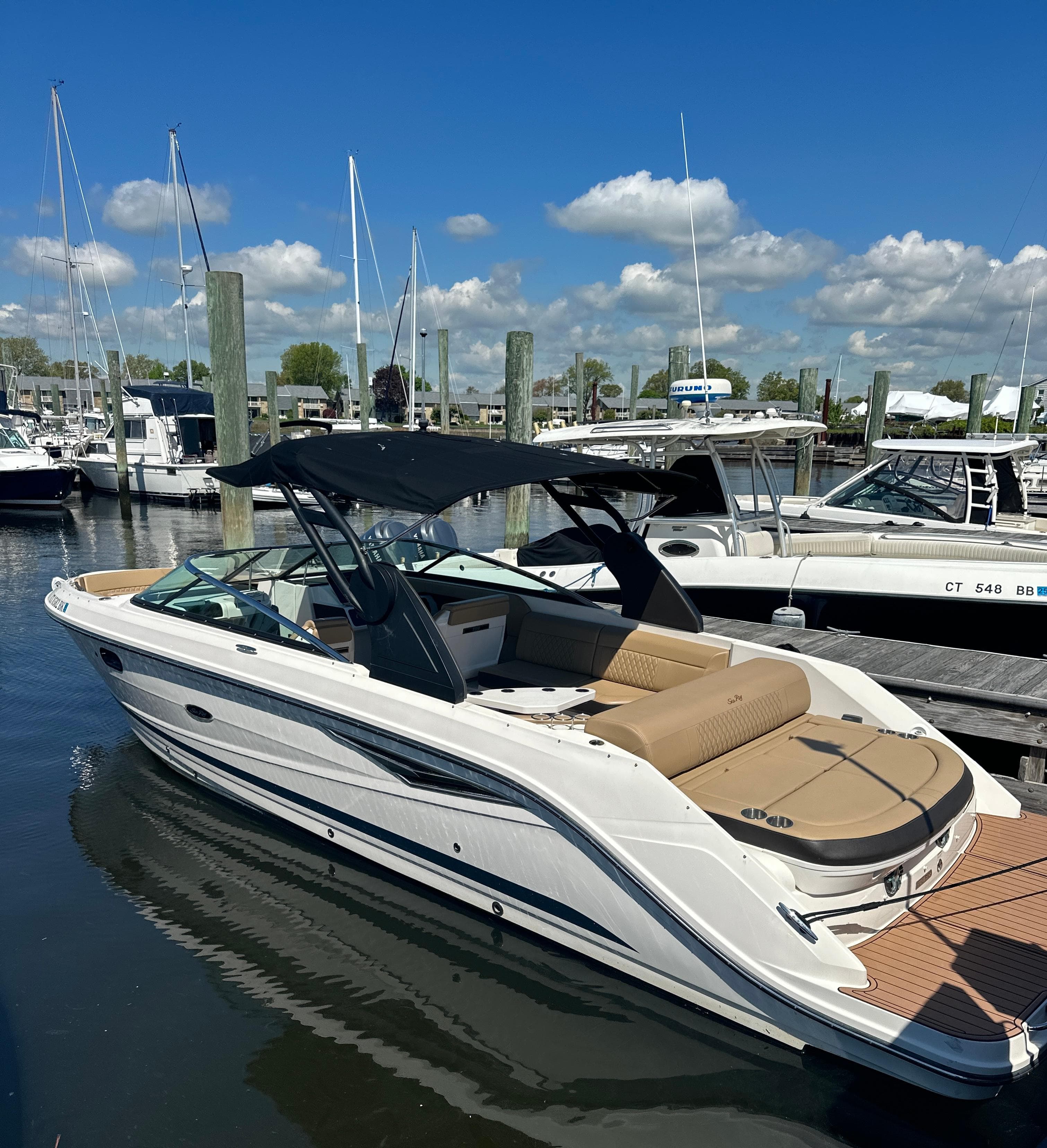 2019 Sea Ray SLX 280 boat docked at marina under clear blue sky.