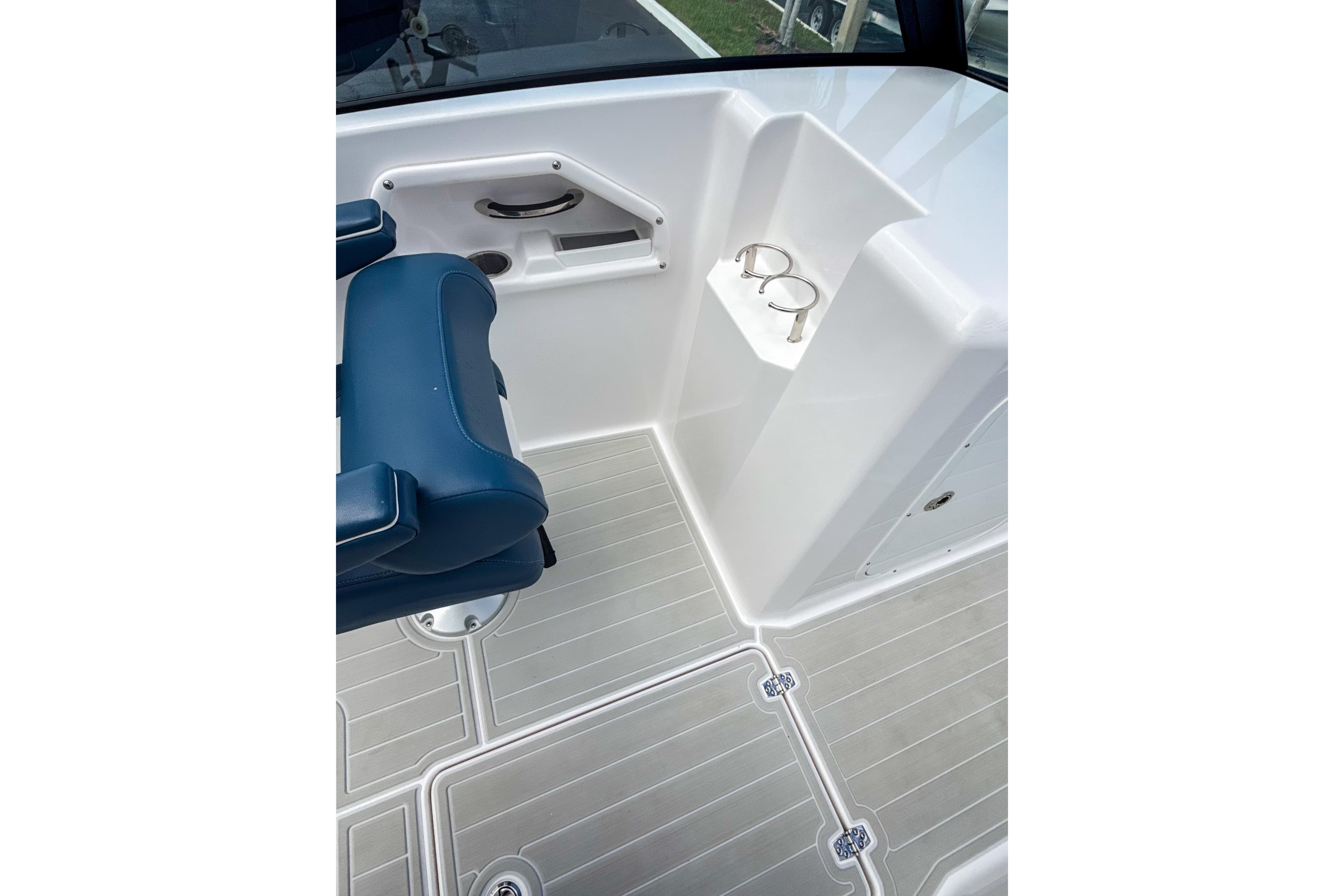 2024 Aquasport AS DC 22 boat interior with blue seating and cup holders.