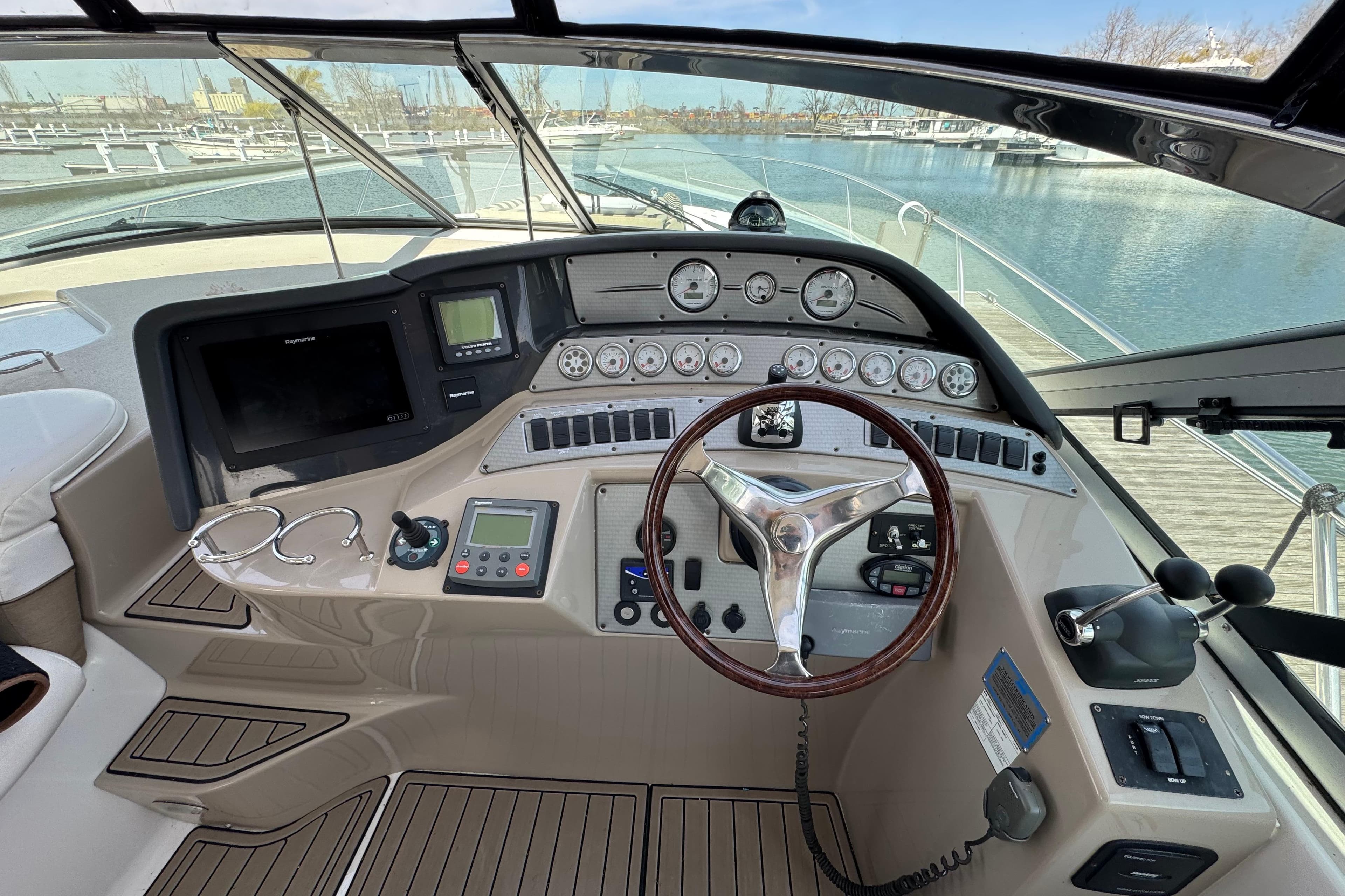 2006 Four Winns 378 Vista helm with steering wheel, gauges, and navigation controls.
