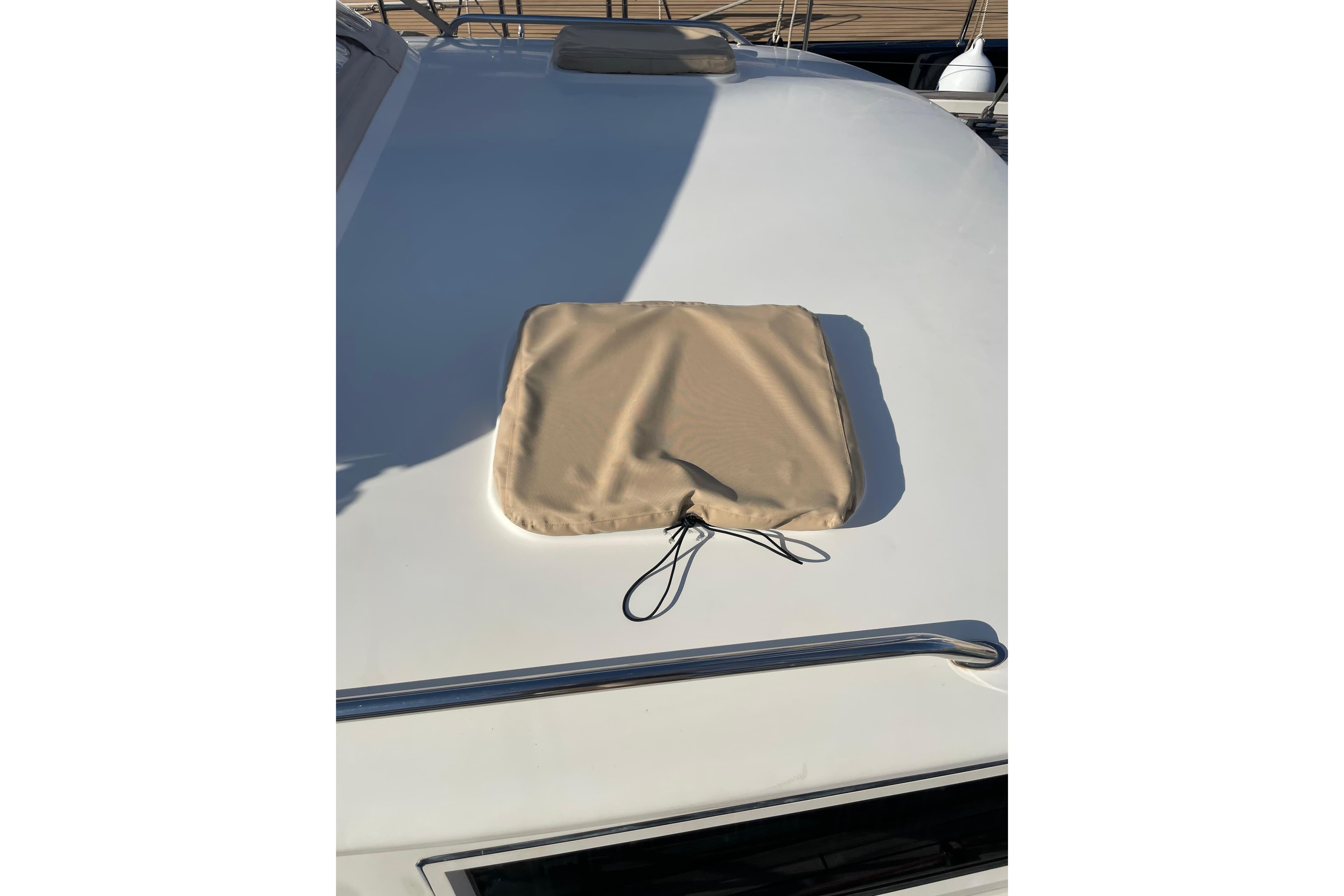 2002 Contest 55CS yacht deck with beige hatch cover and railing.