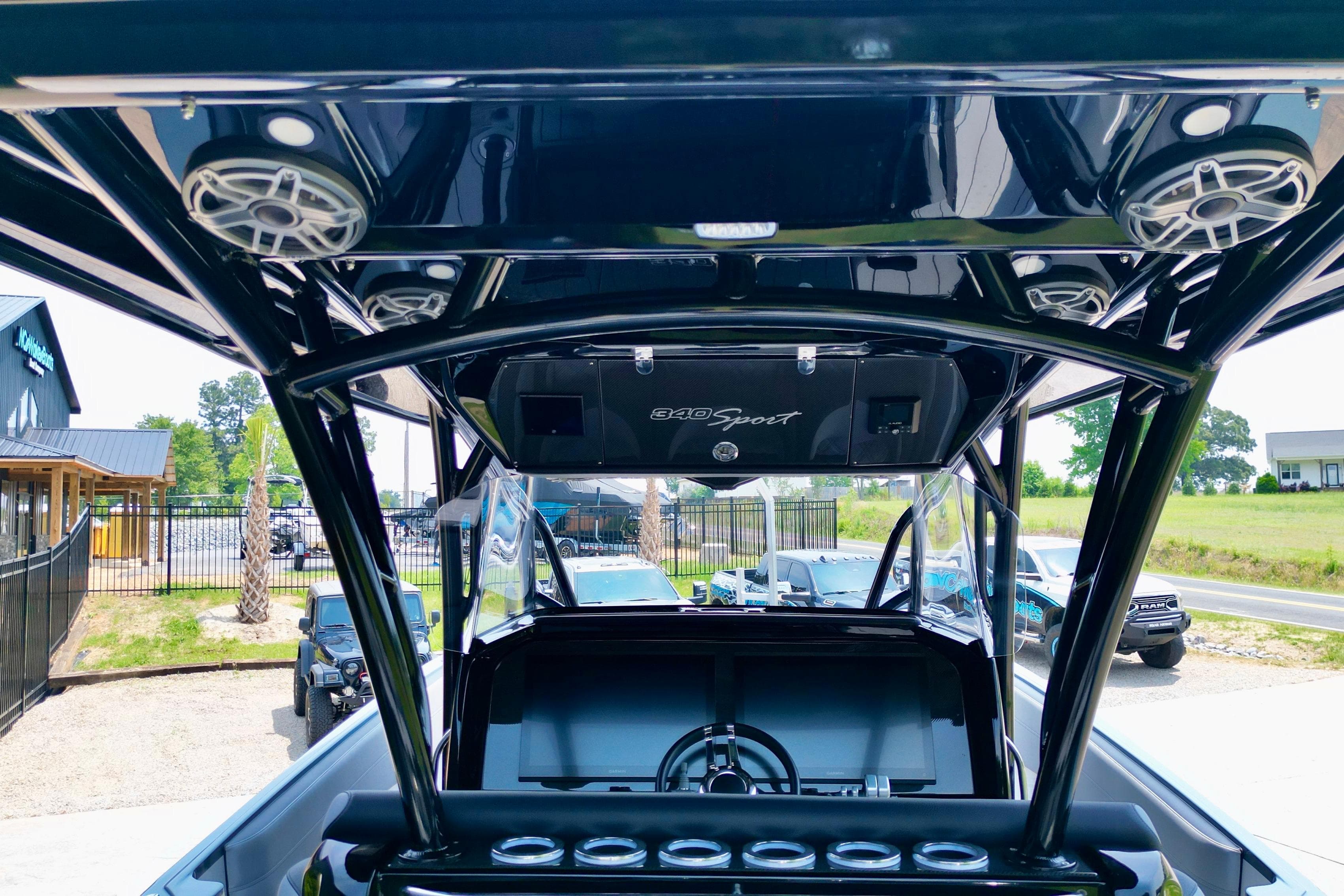 2025 Nor-Tech 340 Sport Center Console boat interior with speakers and steering wheel.