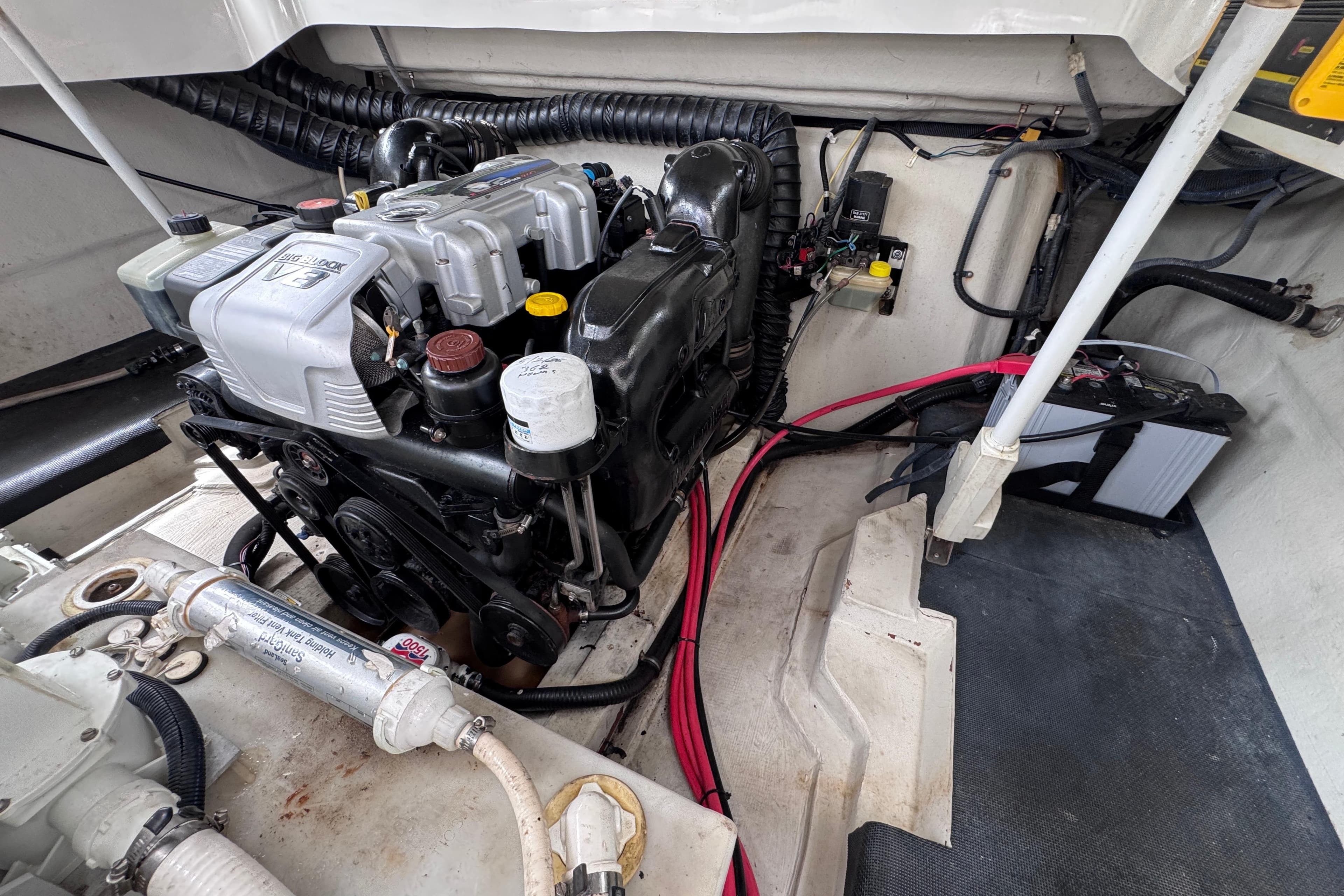 Engine compartment of a 2013 Cobalt 296 boat, showcasing mechanical components and wiring.