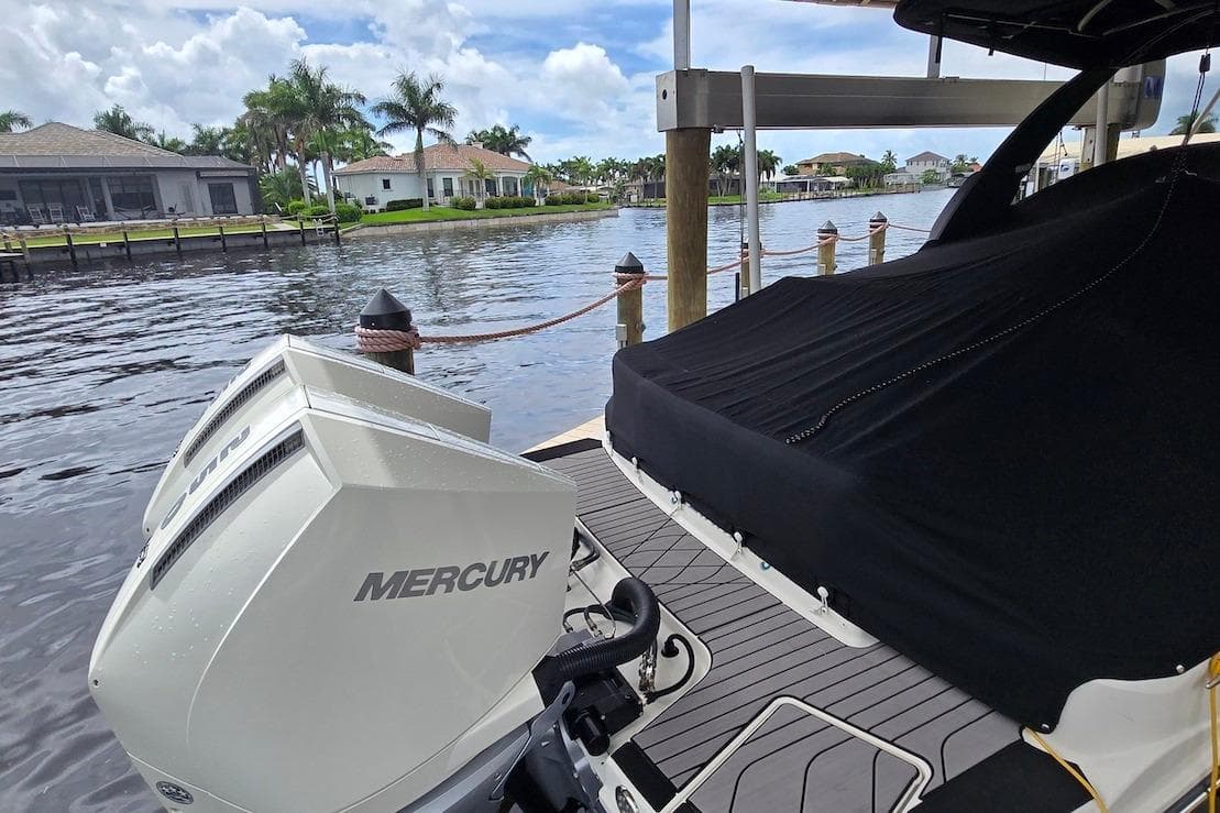 2023 Sea Ray SLX 280 Outboard with Mercury engines docked by waterfront homes.