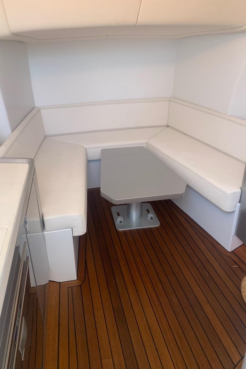 2017 Maori 50 yacht interior with white seating and wooden flooring.