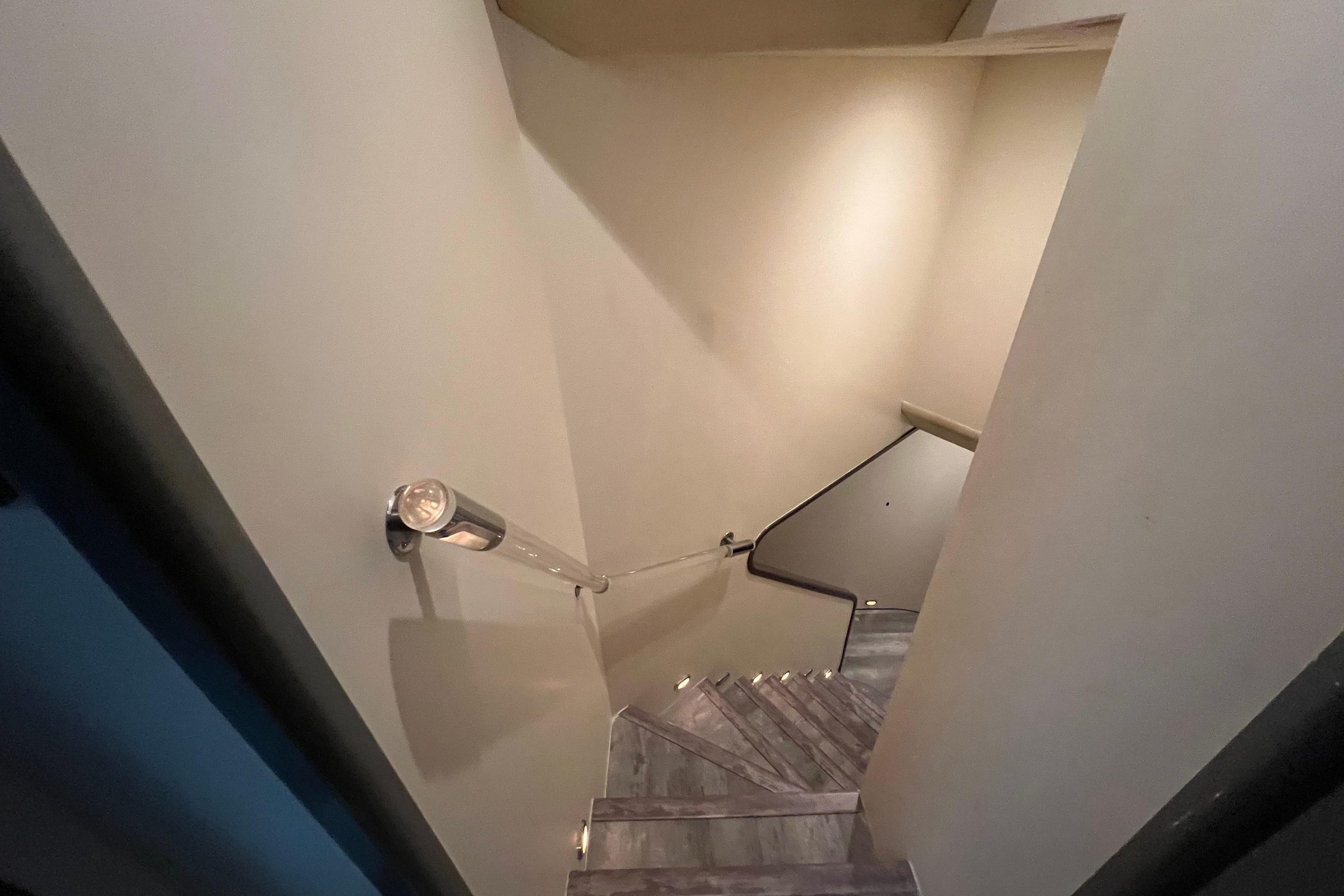 Modern spiral staircase with sleek handrail, inside a Falcon 106 yacht, 2001 model.