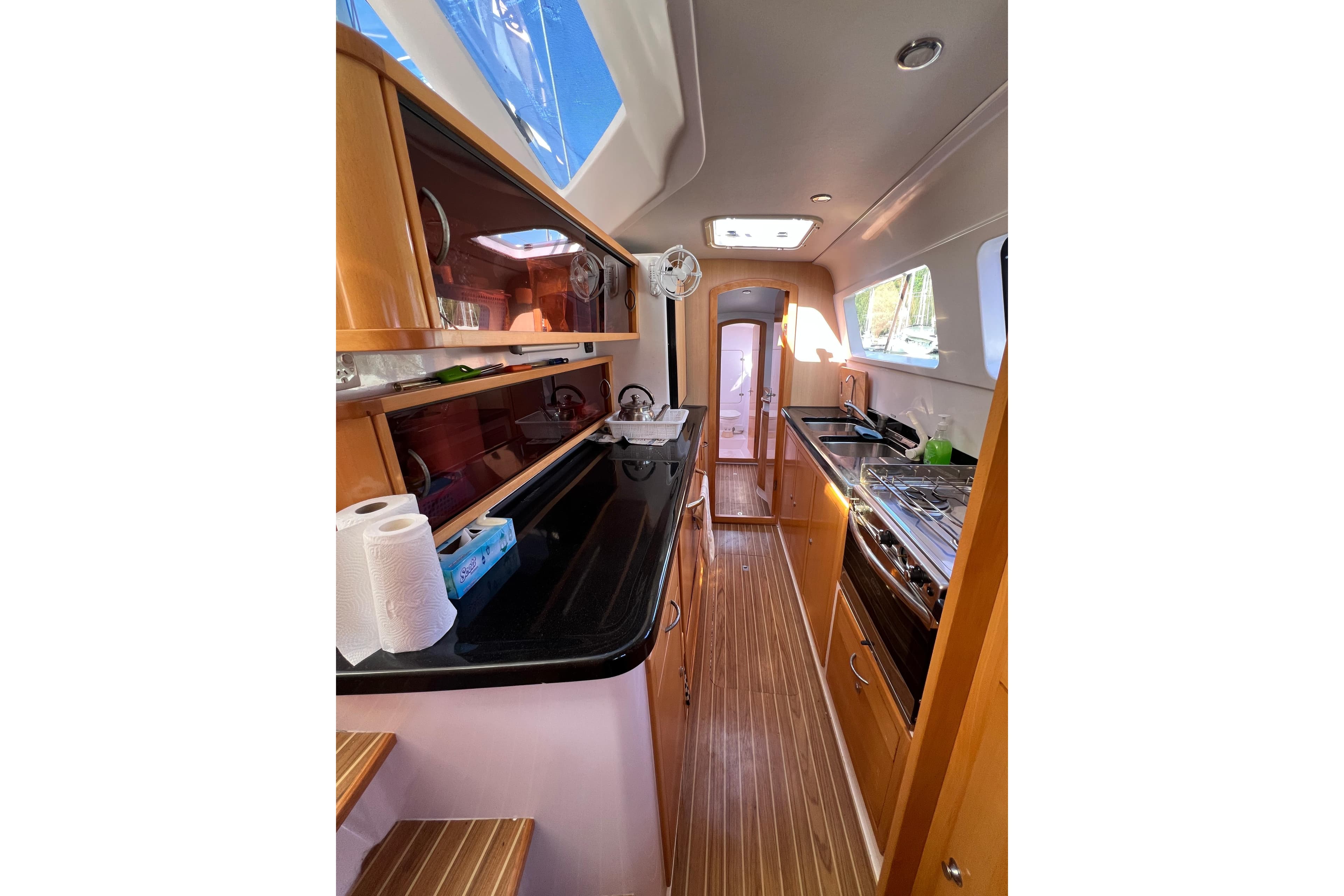 Interior of 2016 Seawind 1250 yacht, featuring a modern kitchen with wood finishes.