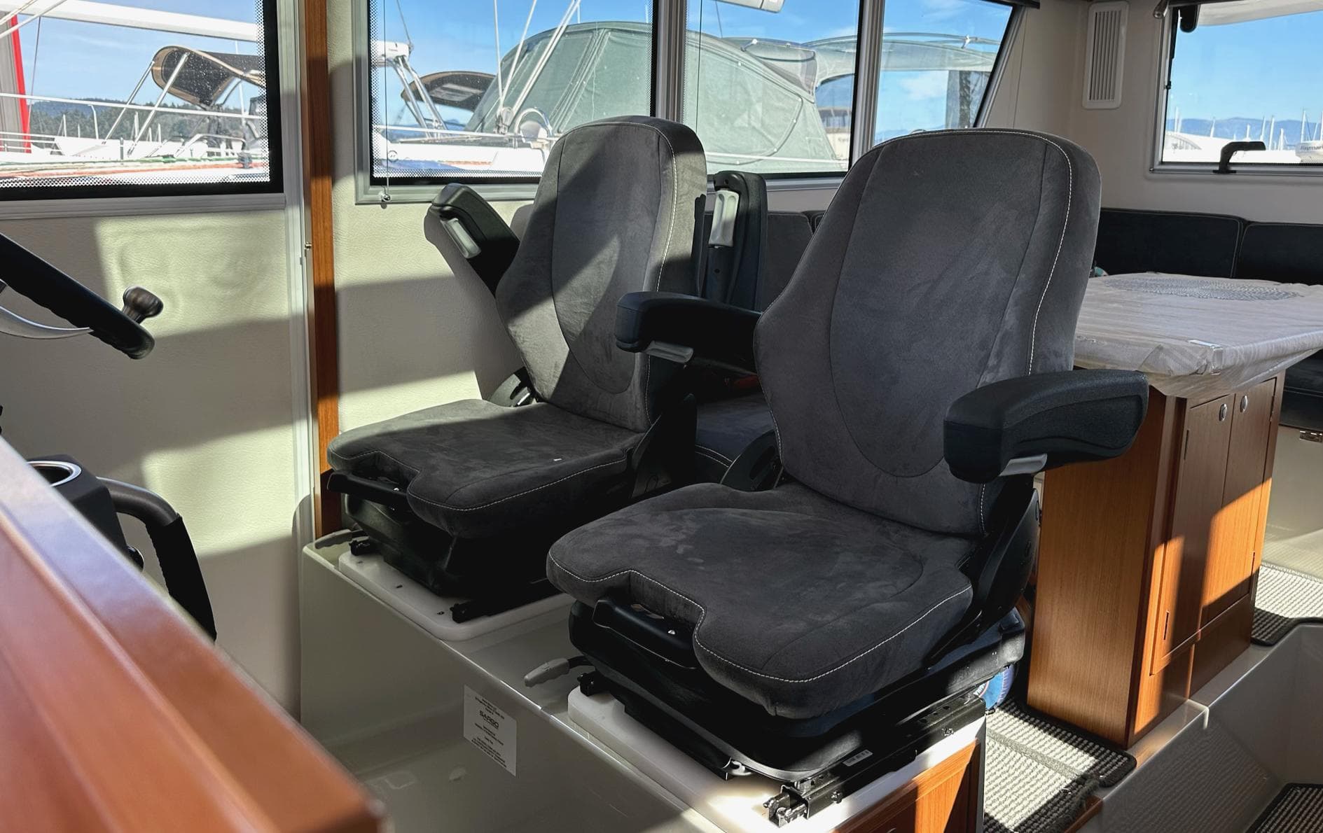 Interior of 2024 Sargo 36 Explorer boat with two black captain's chairs.