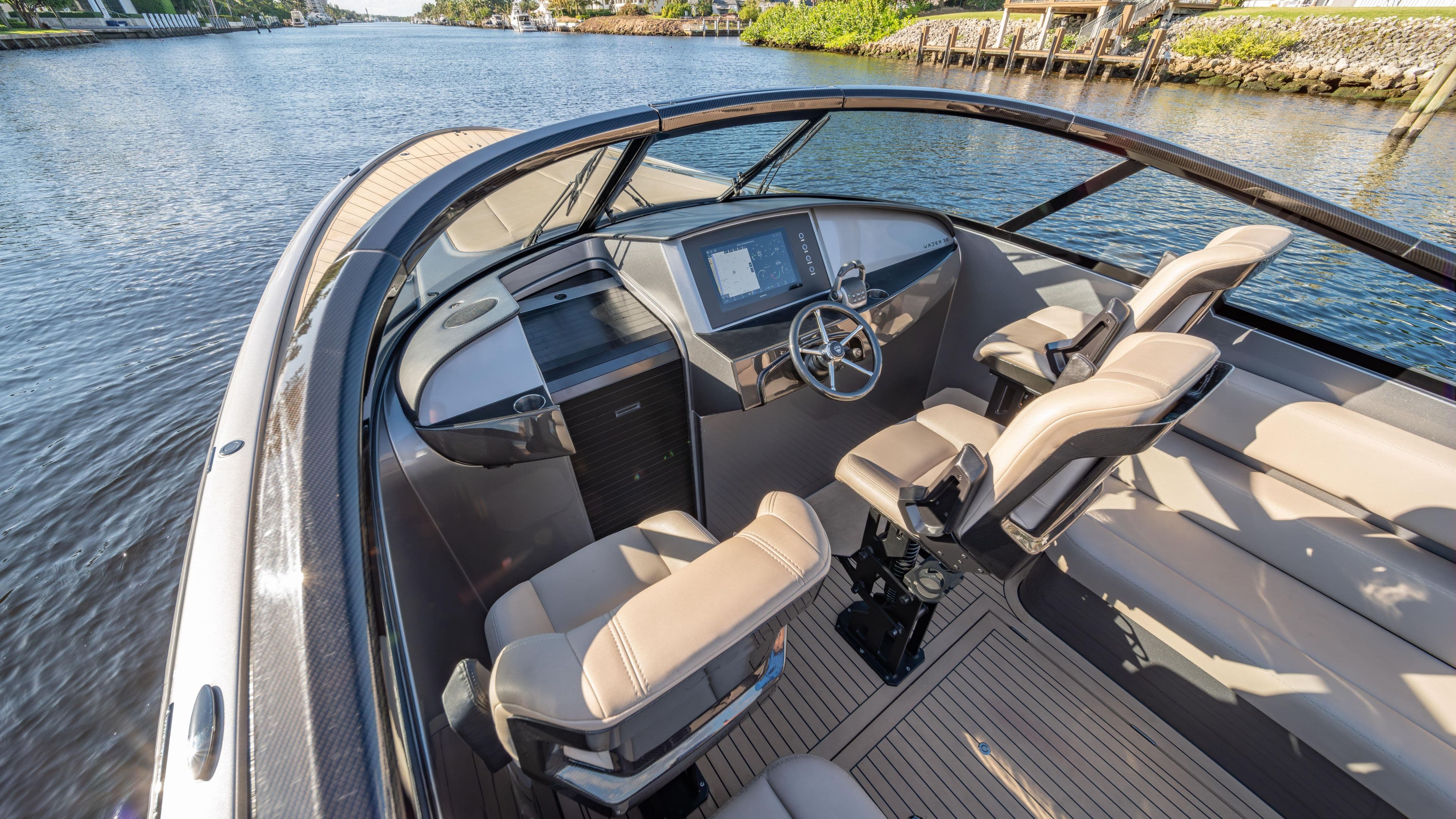 Luxurious 2022 Wajer boat interior with modern dashboard and comfortable seating on a serene waterway.