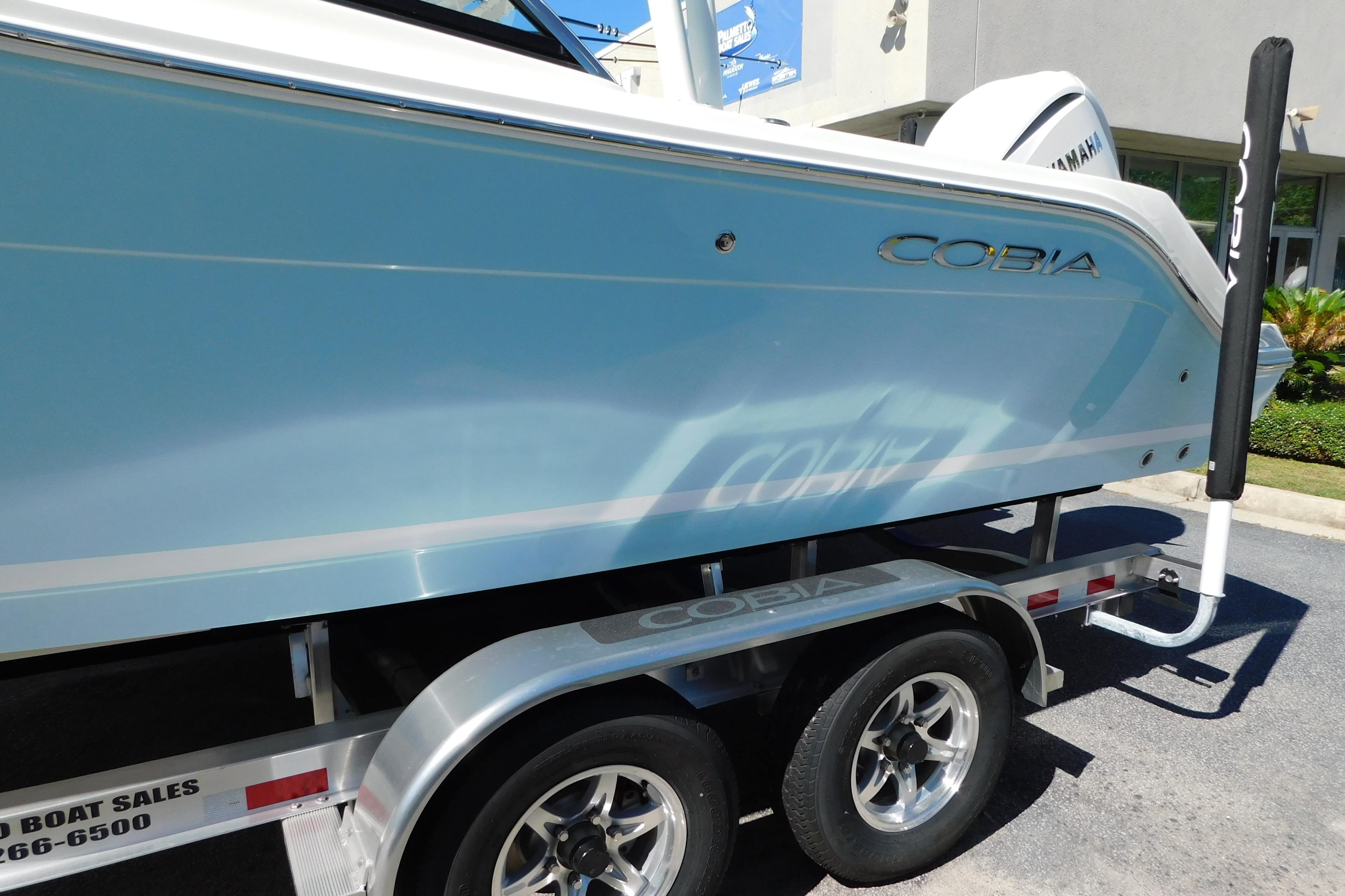 2026 Cobia 240 Dual Console boat on trailer, side view.