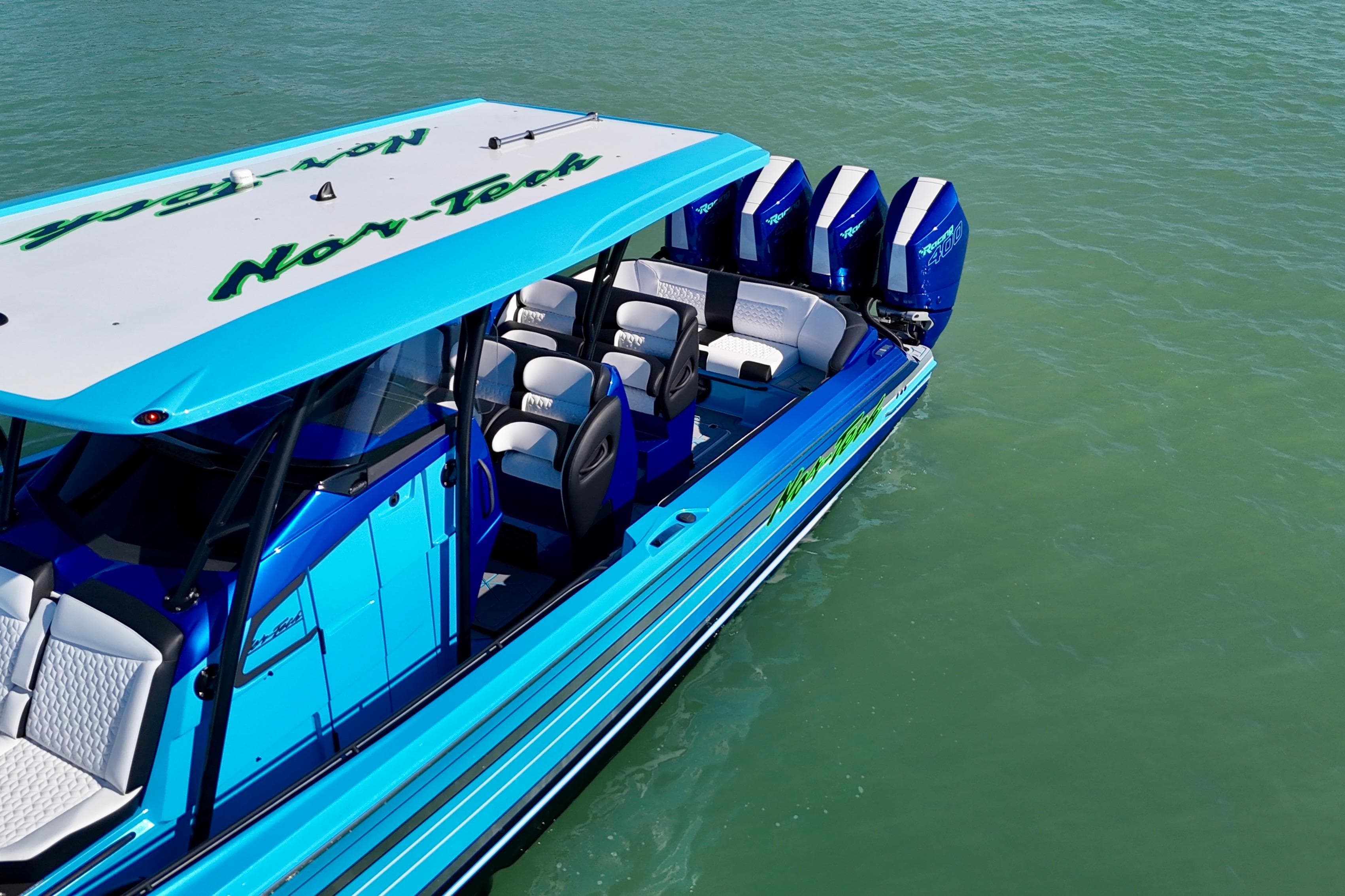 2026 Nor-Tech 390 Sport Center Console boat on water, featuring vibrant blue design.