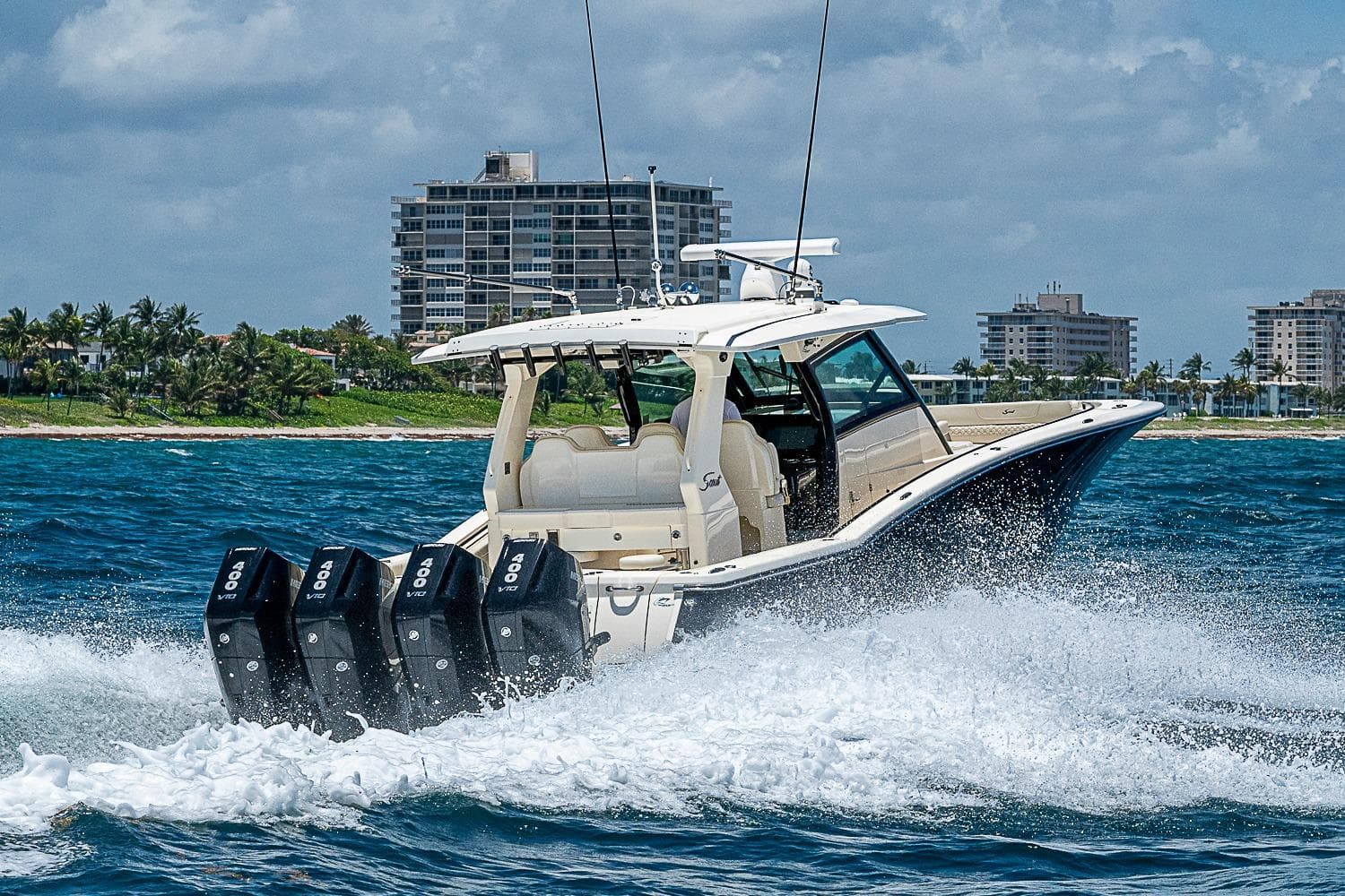 2025 Scout 425 LXF boat cruising on ocean with four powerful engines.
