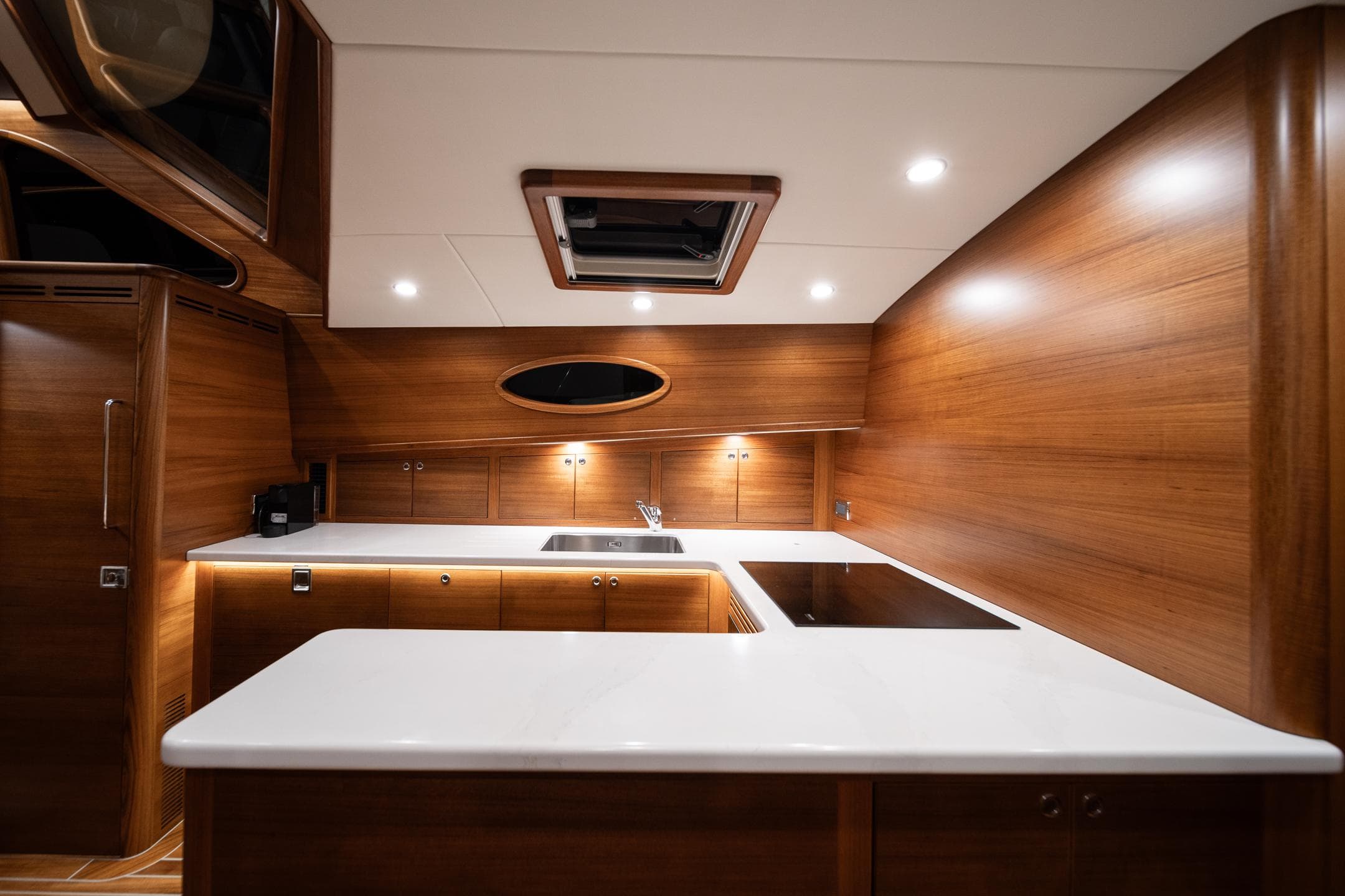 Luxurious kitchen interior of 2026 Palm Beach Motor Yachts PB70 with modern wood finish.