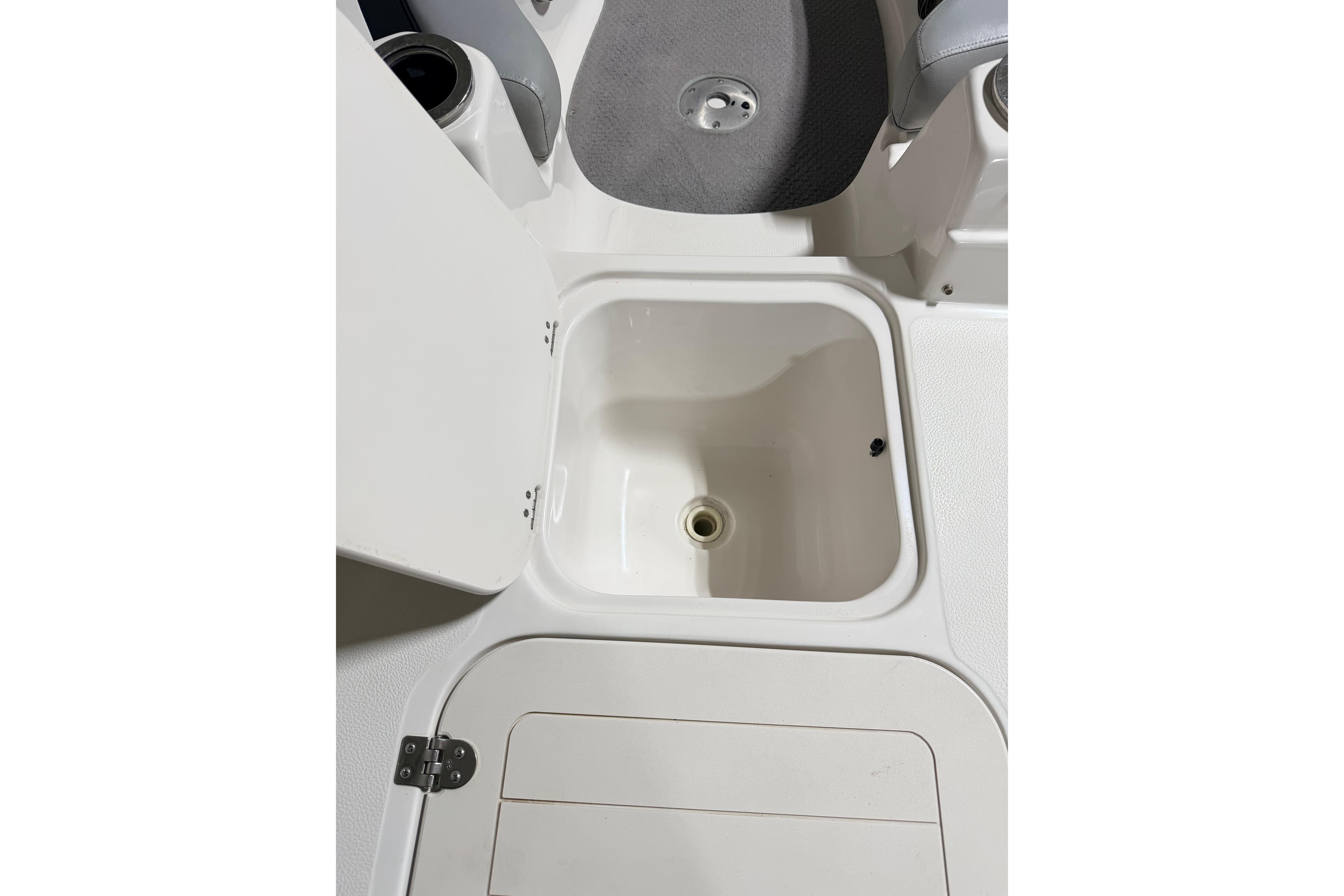 Open storage compartment on 2014 Starcraft 2000 IO Limited boat.