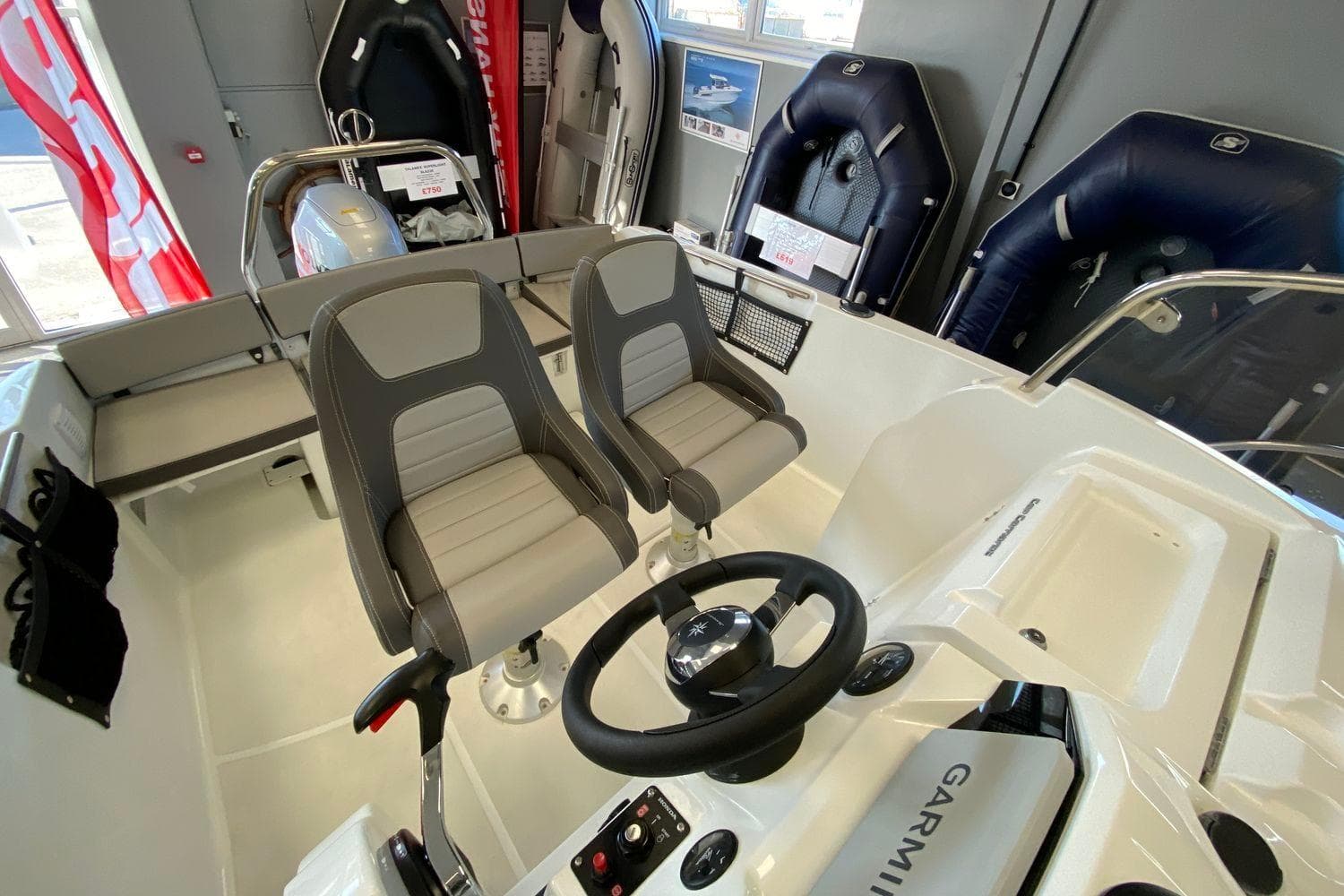2026 Jeanneau Cap Camarat 5.5 CC Serie 2 boat interior with dual seats and steering console.