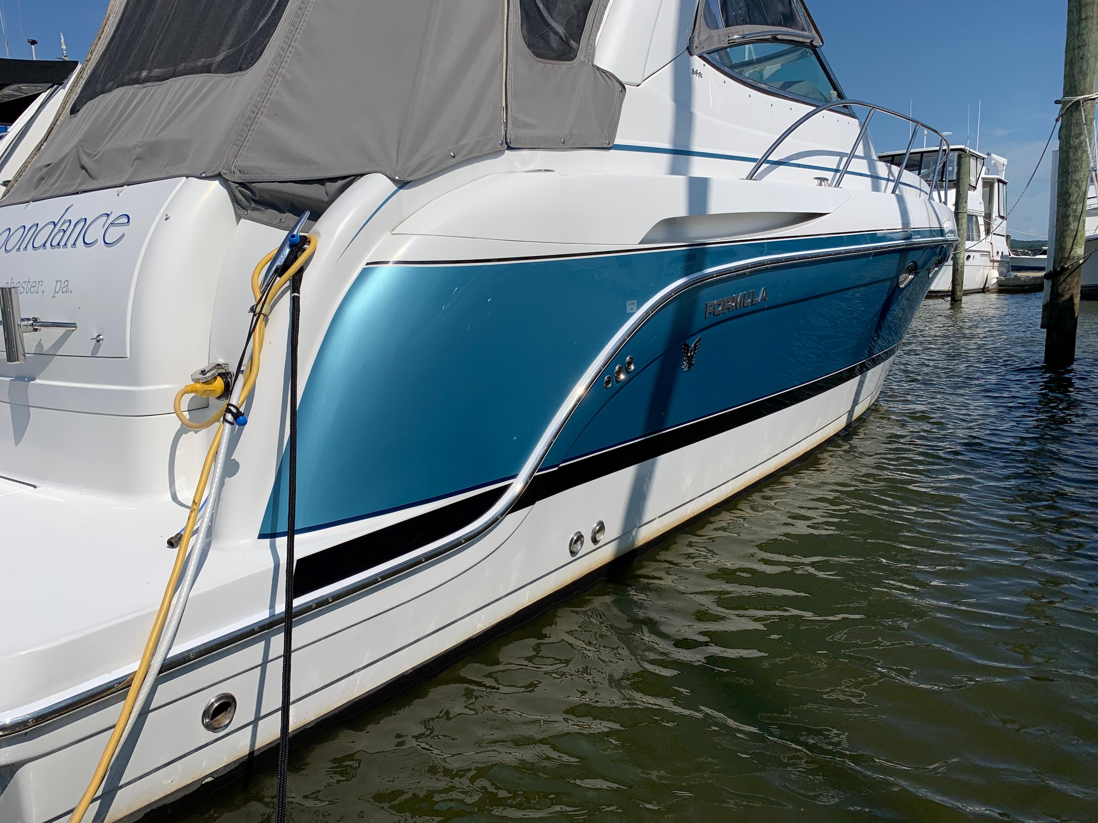 2005 Formula 34 PC boat docked in marina.