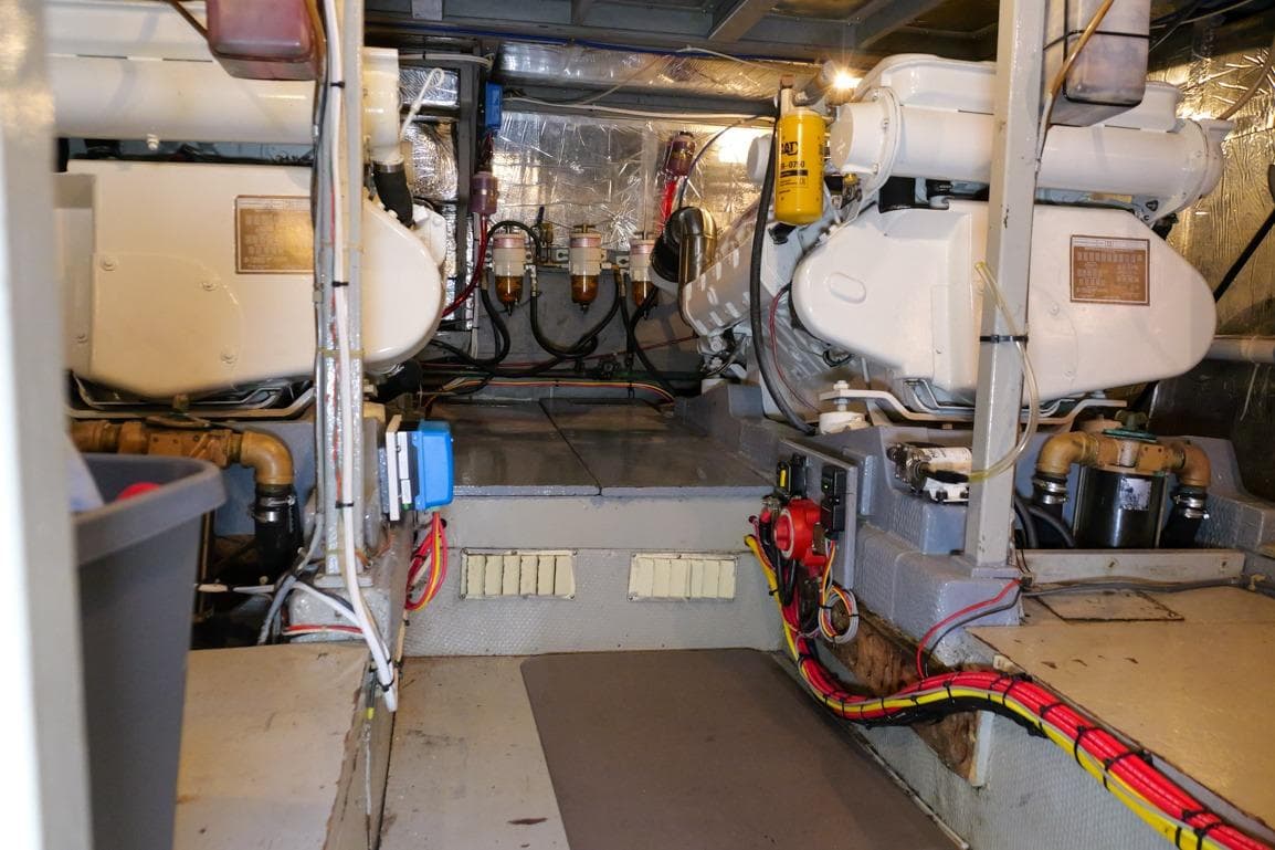 Engine room of 1981 Tollycraft 48 Cockpit Motor Yacht, showcasing dual engines and wiring.