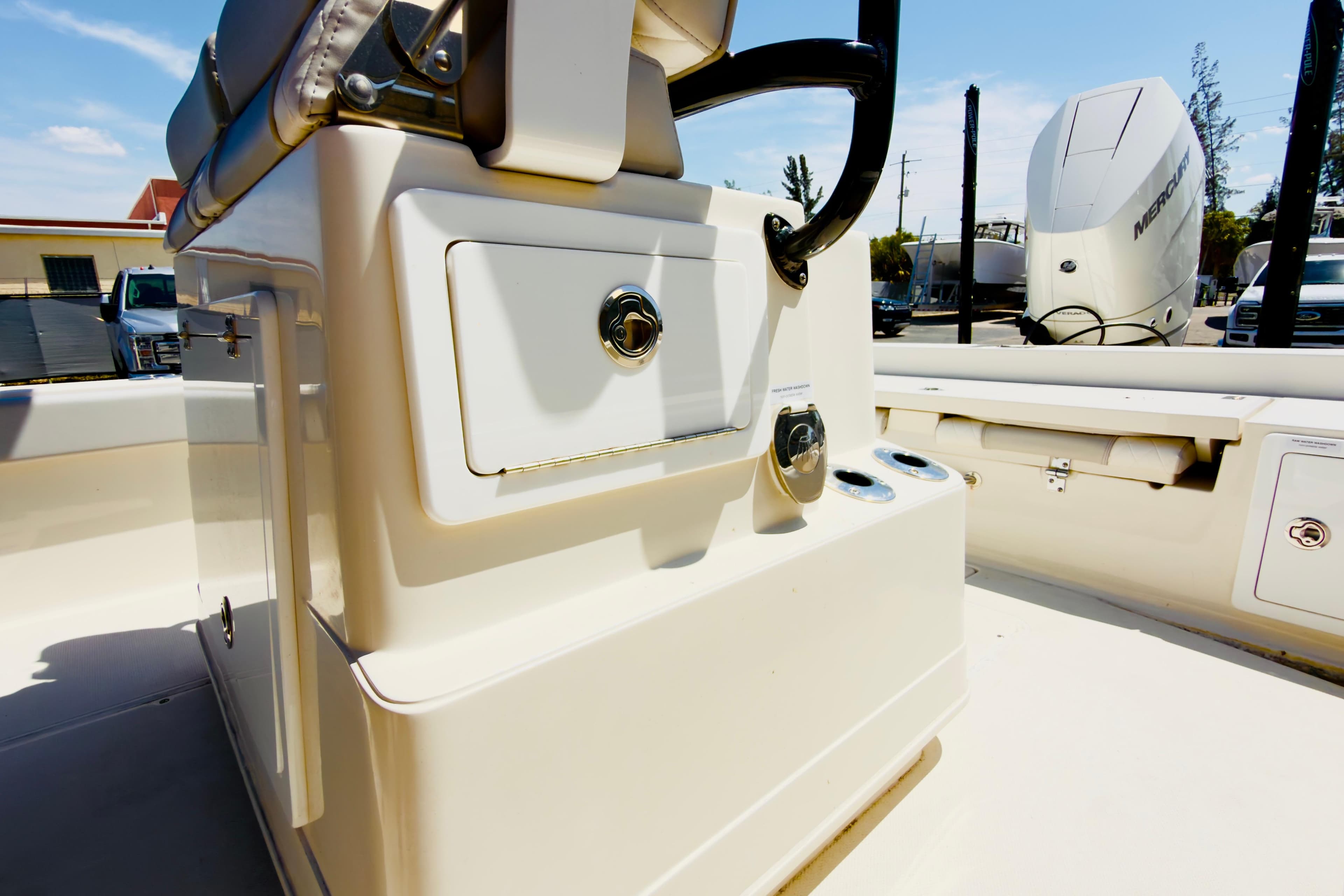 2024 Ranger 2660 Bay boat interior with storage compartments and Mercury engine in background.