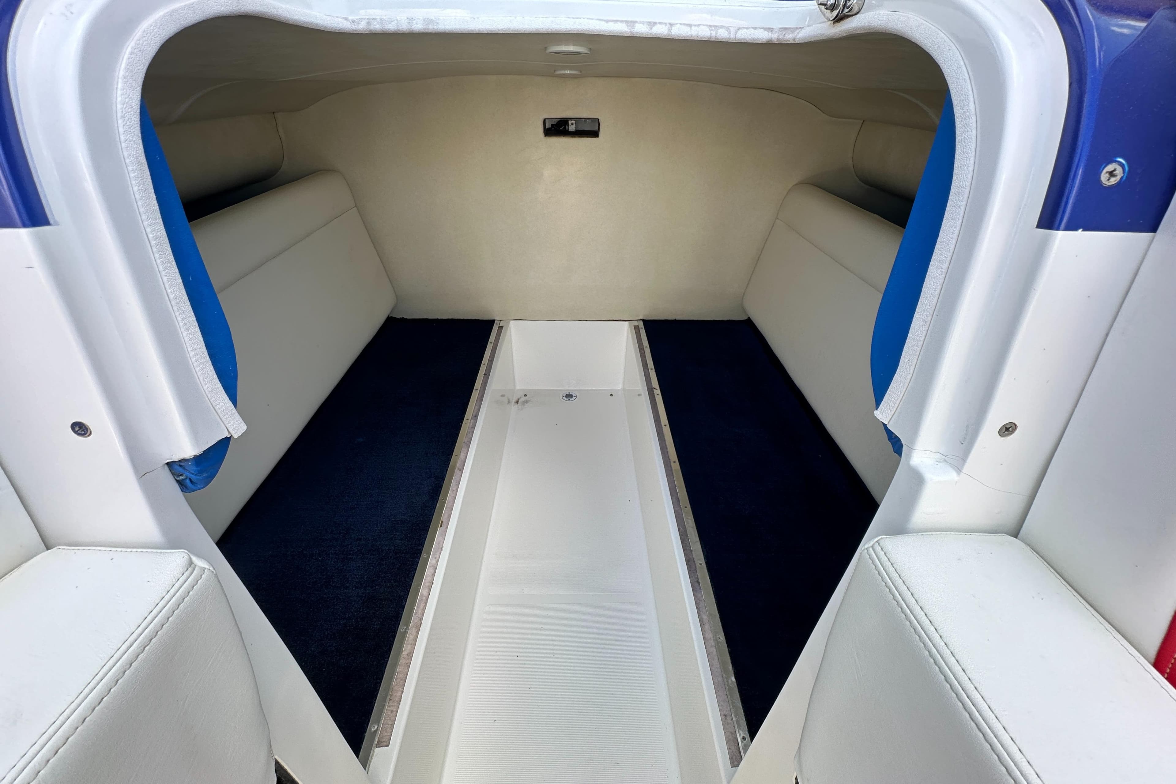 Interior of 2003 Hustler 377 Talon boat, featuring spacious seating and sleek design.