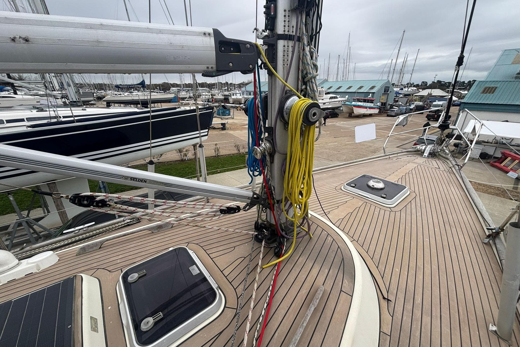 Deck of a 1994 Najad 360 sailboat with rigging and marina background.