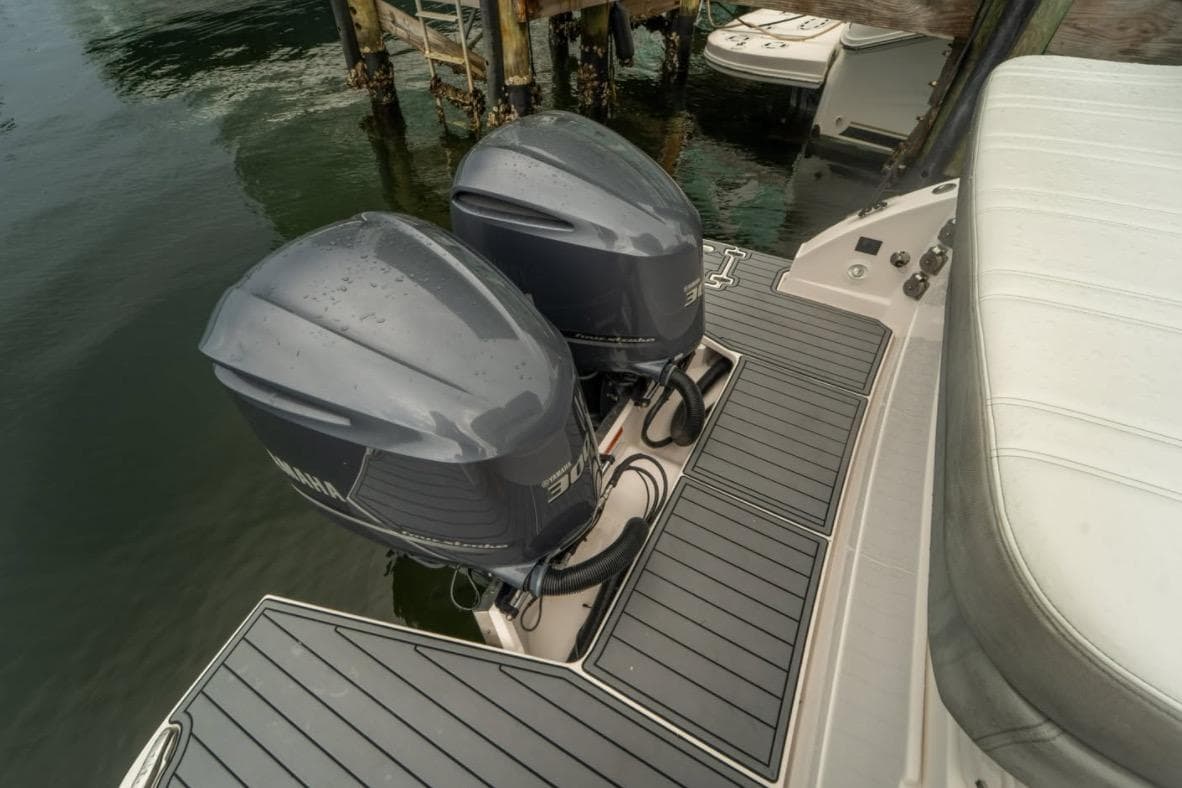 2021 Regal 33 OBX boat with dual outboard engines on a sleek deck.