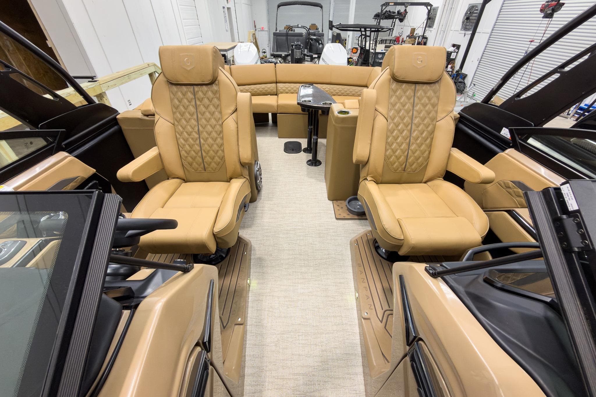 Luxurious interior of 2026 Godfrey Sanpan 27' Tritoon with tan leather seating.