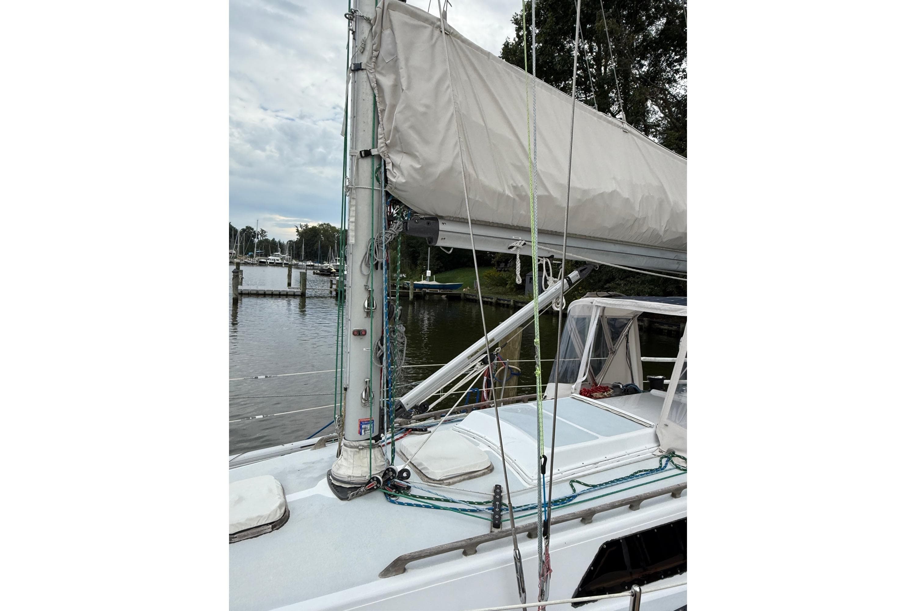 Sailboat deck view of 1988 Sparkman & Stephens 36, docked by a calm marina.