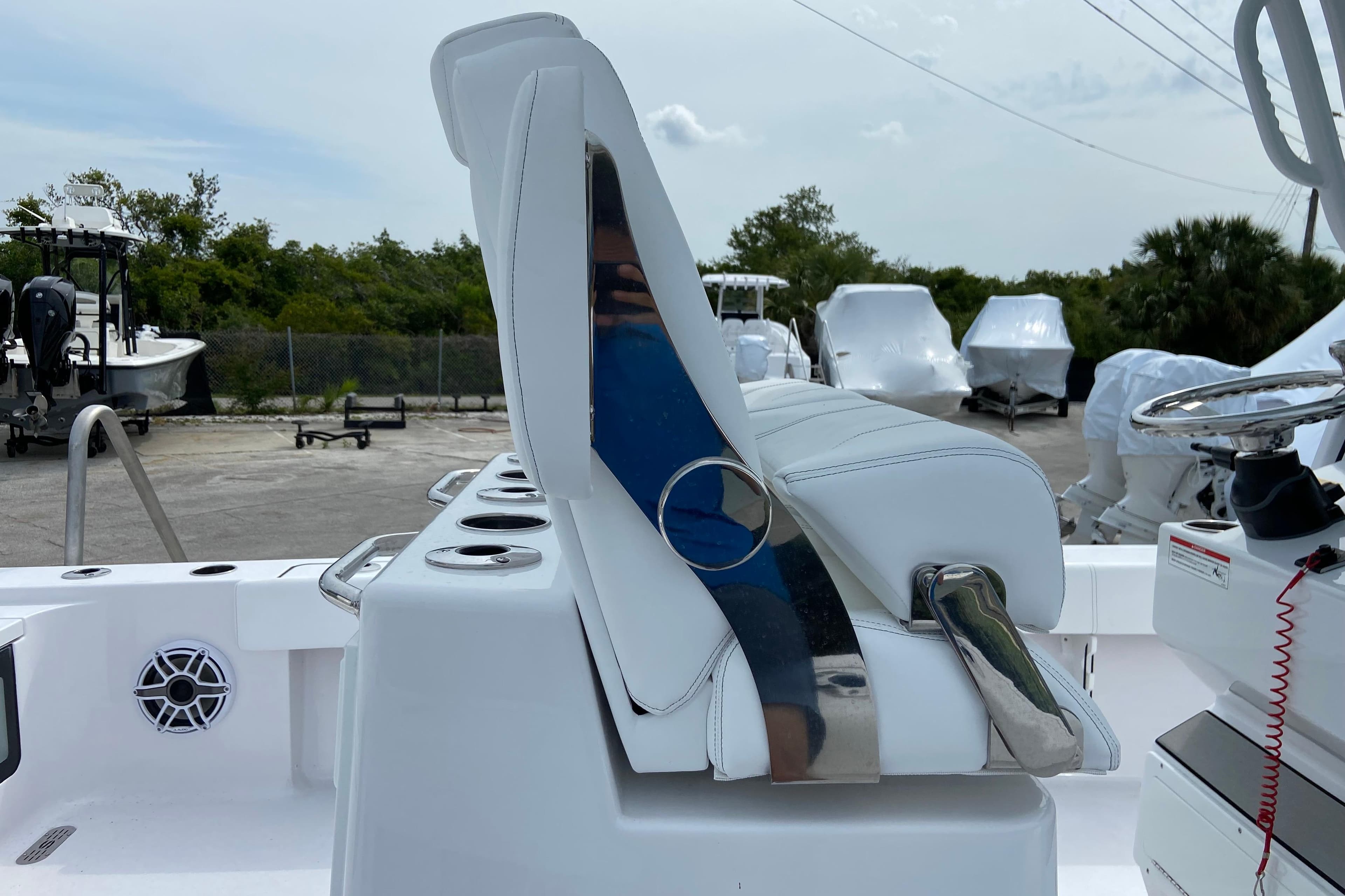 2026 Sportsman Masters 267 Bay Boat interior with white seating and steering console.