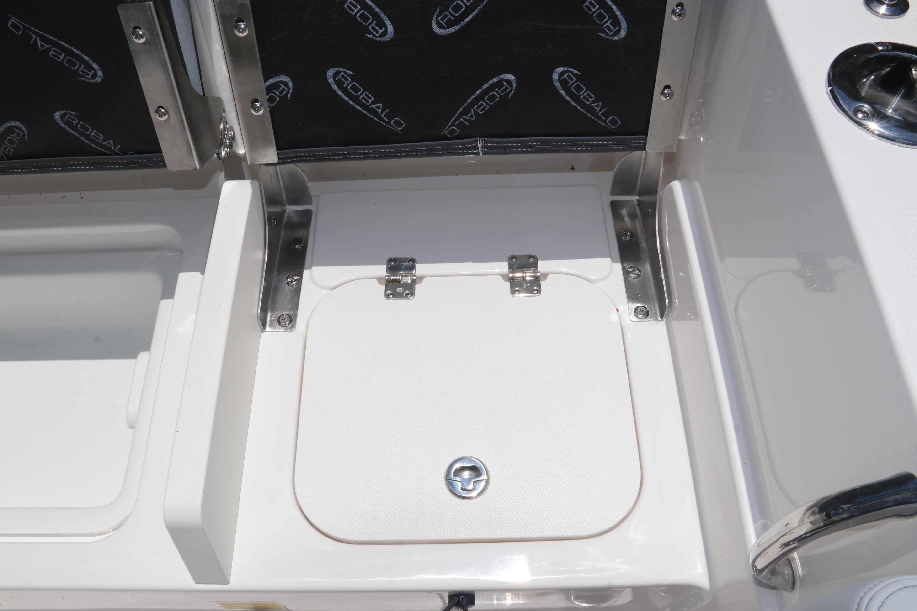 2026 Robalo R232 Explorer boat storage compartment with stainless steel hinges and latch.