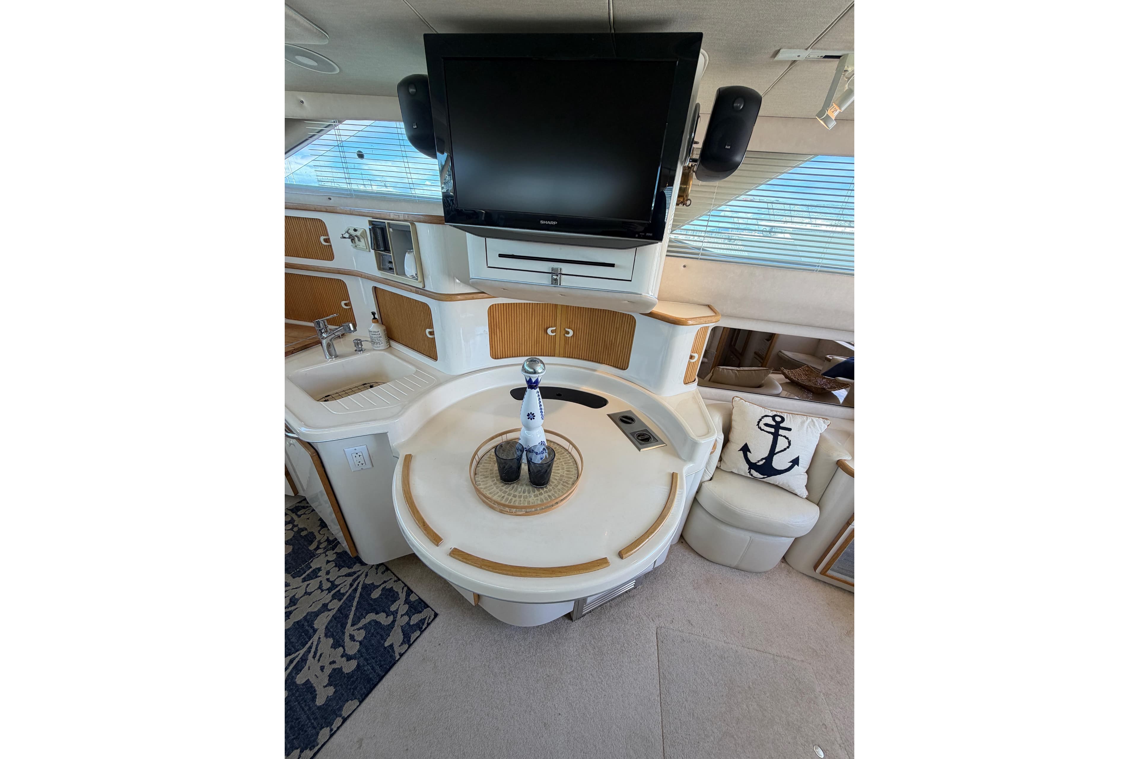 Interior of 1994 Sea Ray 440 Express Bridge with TV, sink, and nautical decor.