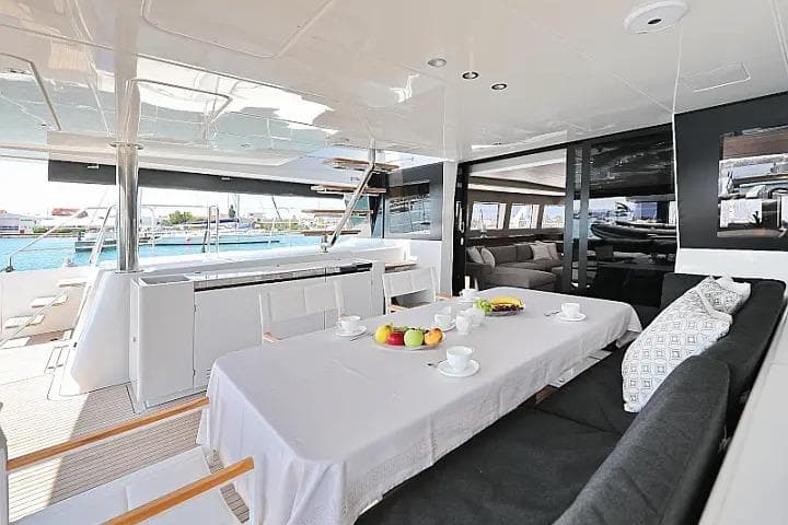 Luxurious interior of 2018 Lagoon 620 Esense yacht with elegant dining area and modern design.