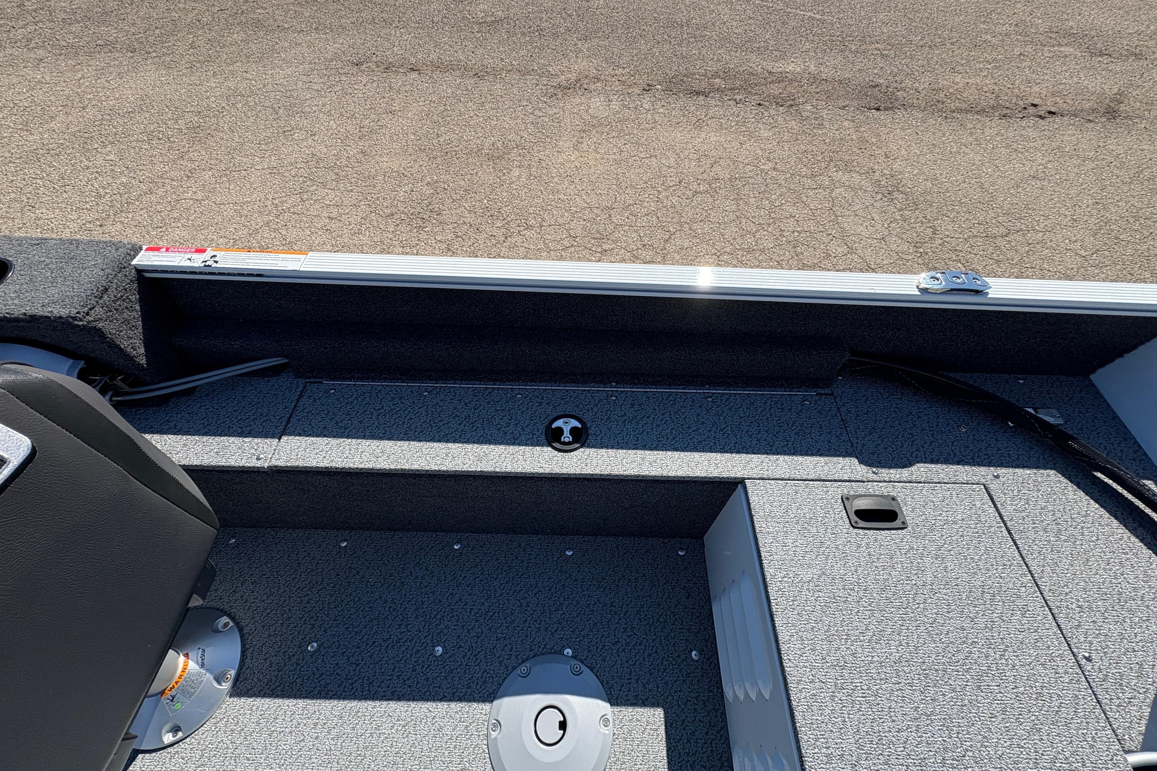 2026 Lund 1650 Angler SS boat interior with seating and storage compartments.
