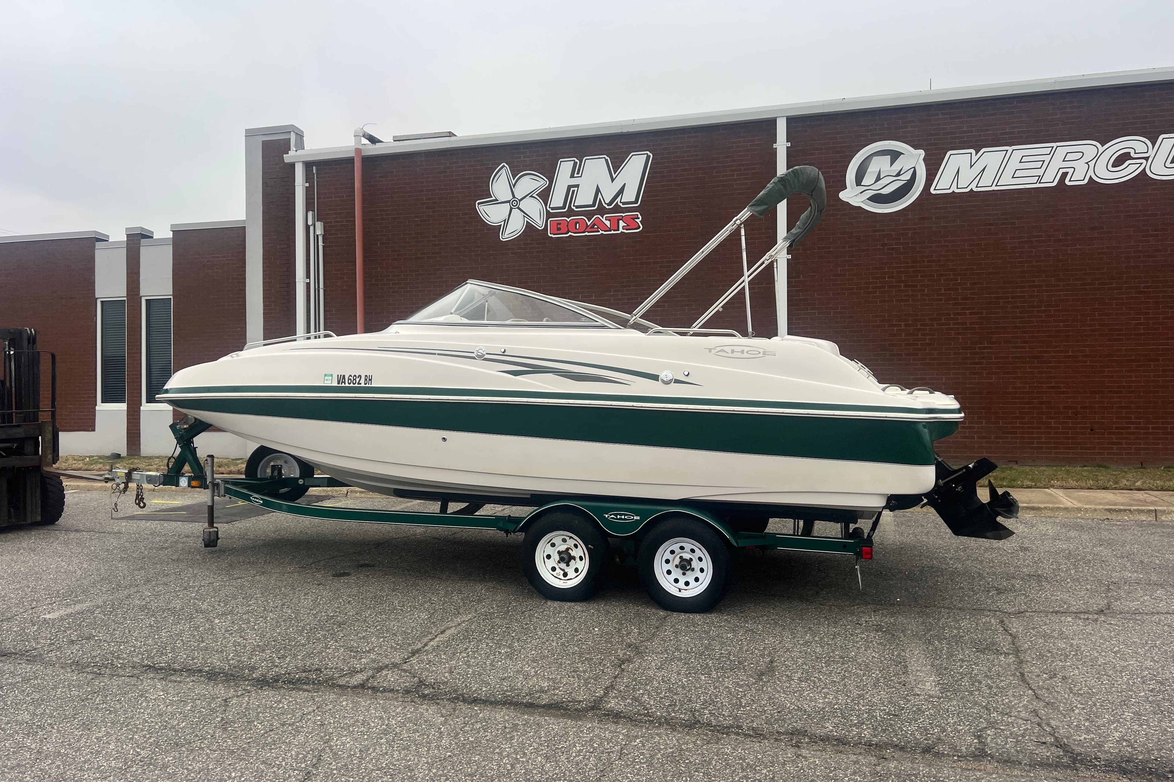 2005 Tahoe 234 boat on trailer outside HM Boats building.