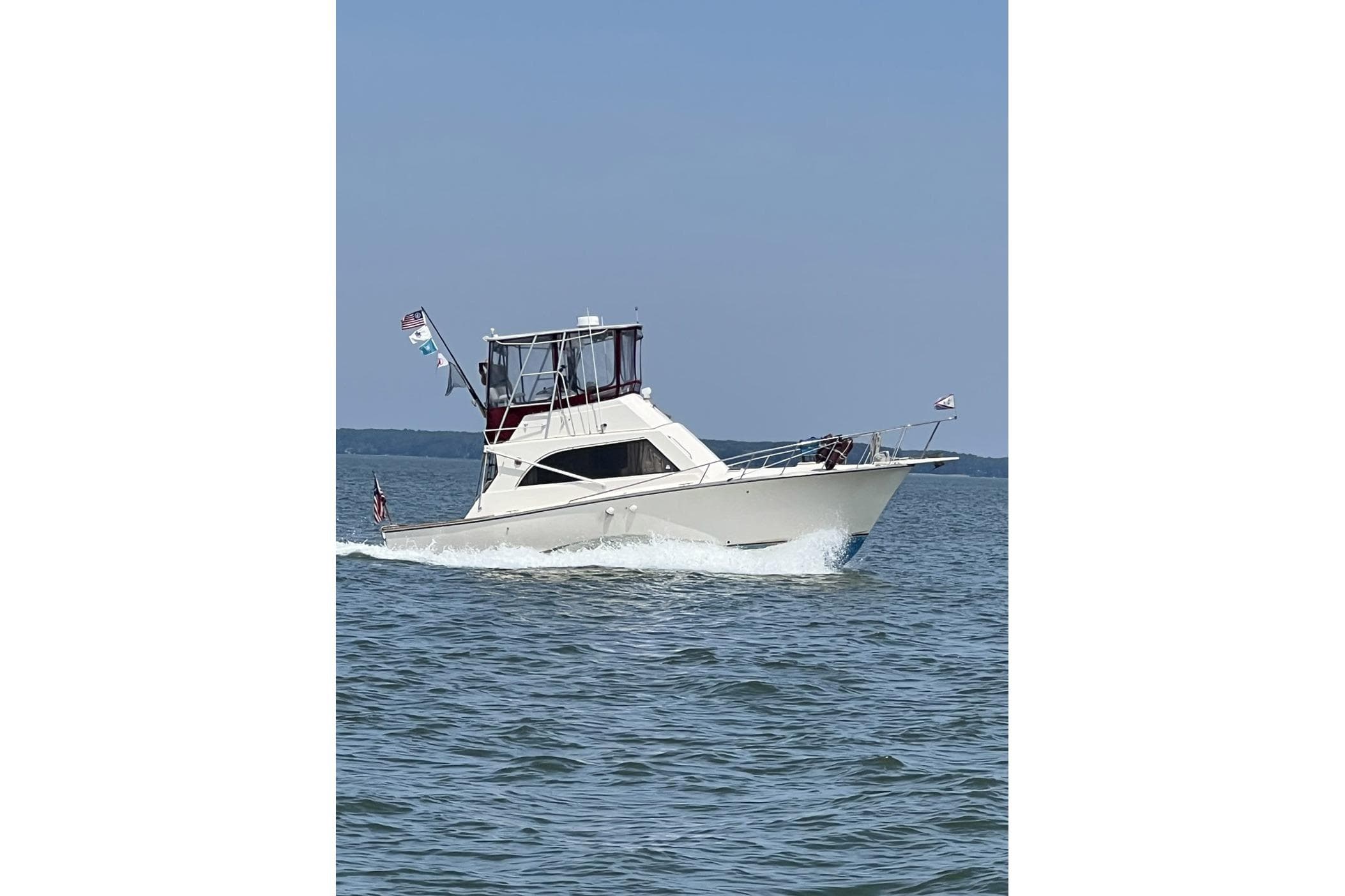 1991 Pace 36 boat cruising on open water under clear blue sky.