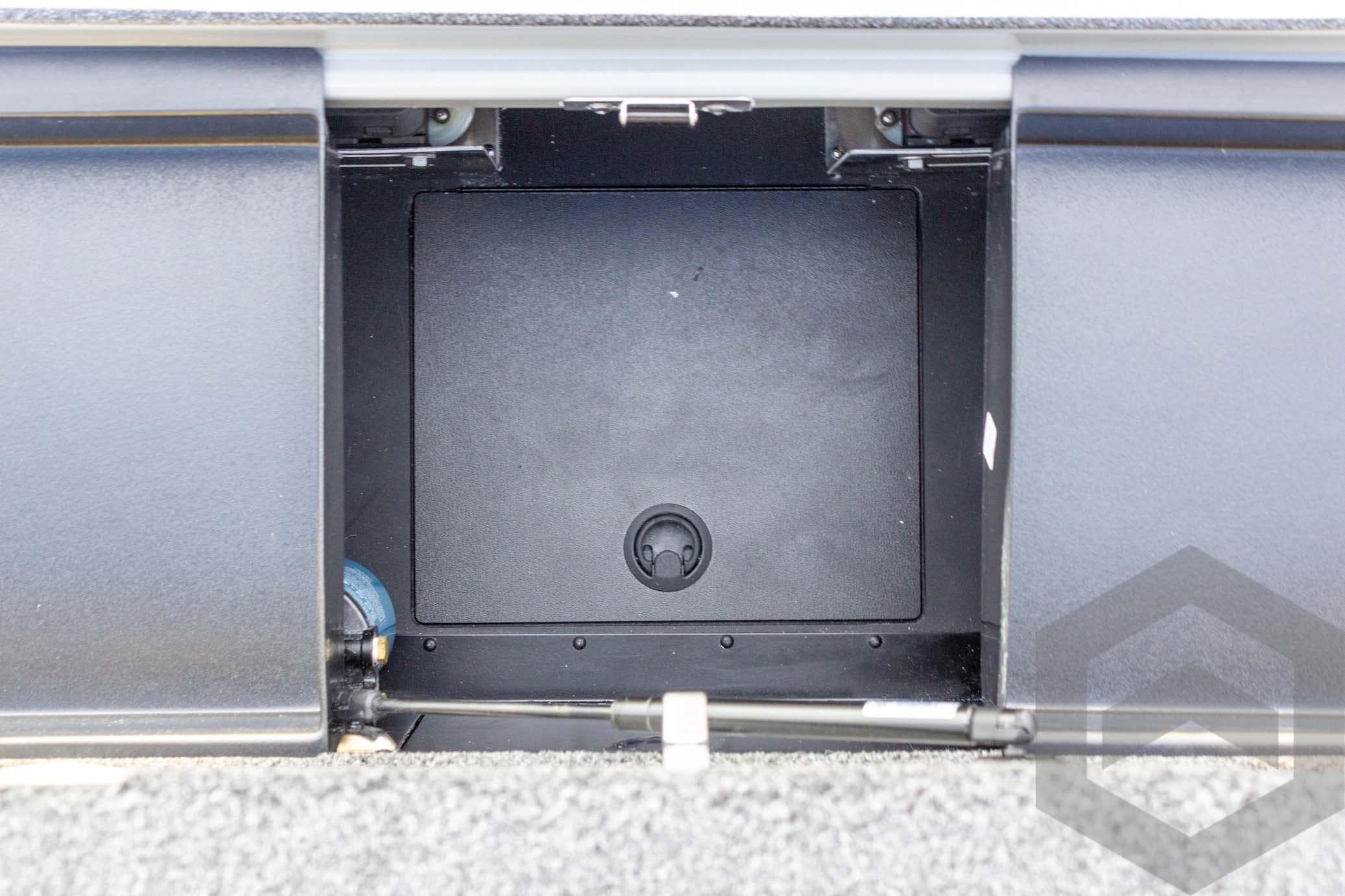 Storage compartment of 2026 Caymas CX 21 PRO boat, featuring a sleek black interior.