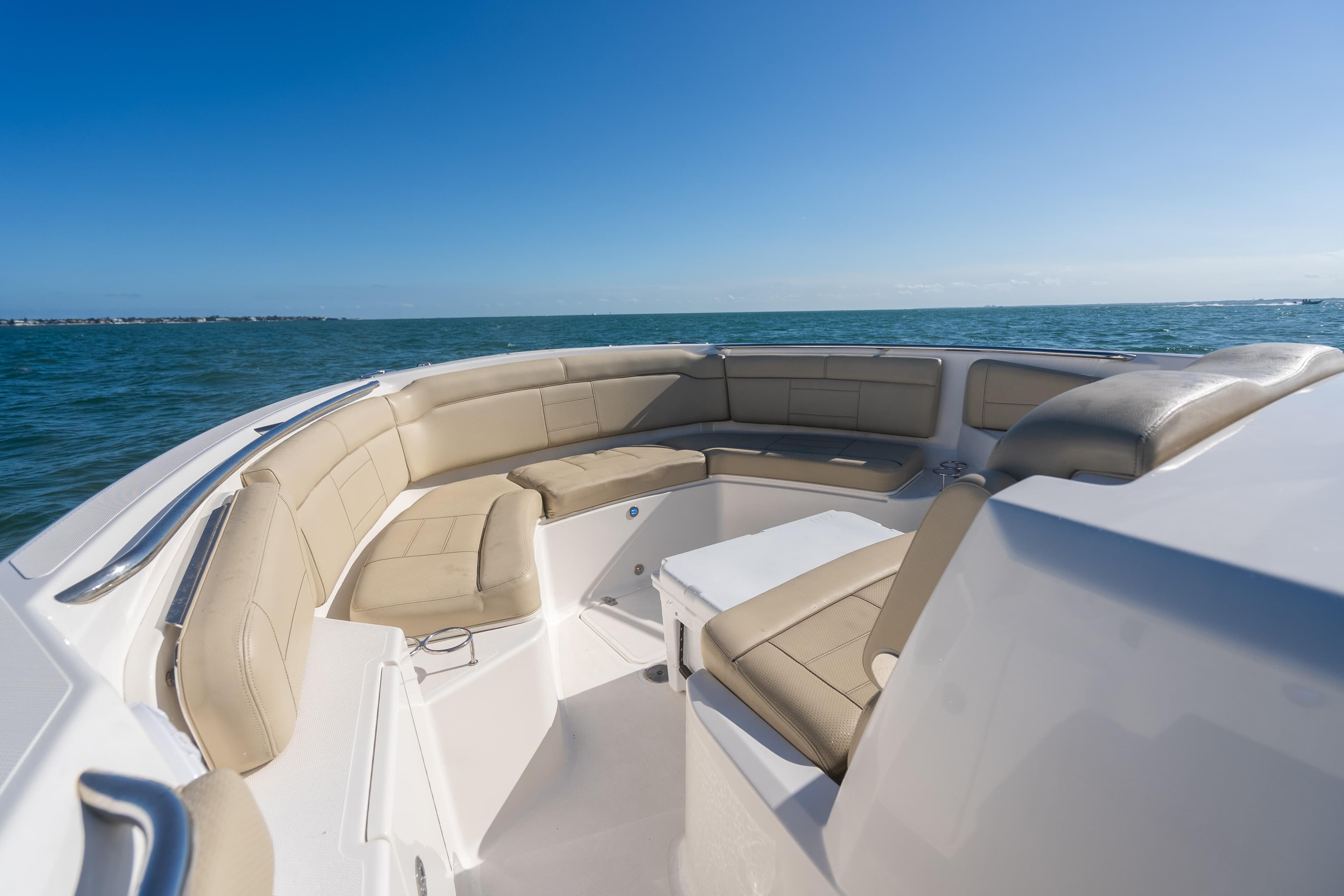 2018 Pursuit S 328 Sport boat with beige seating on open water.