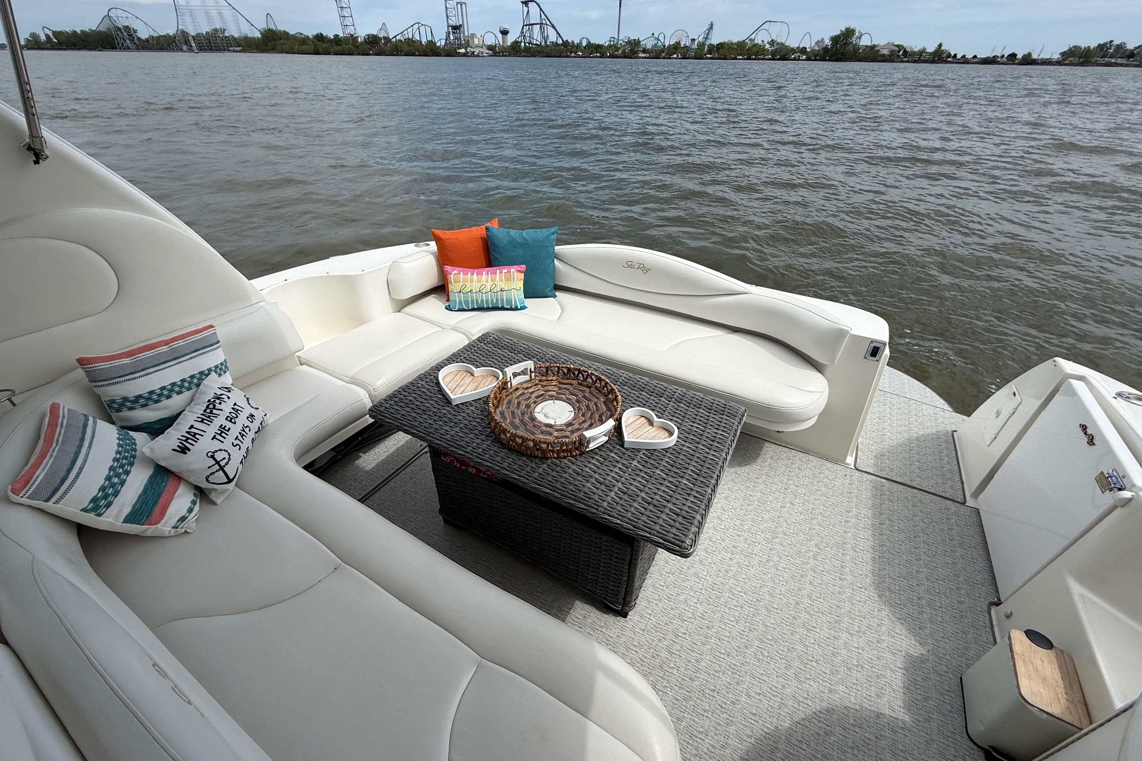 Luxurious 2000 Sea Ray 410 Sundancer yacht with cozy seating and scenic water view.