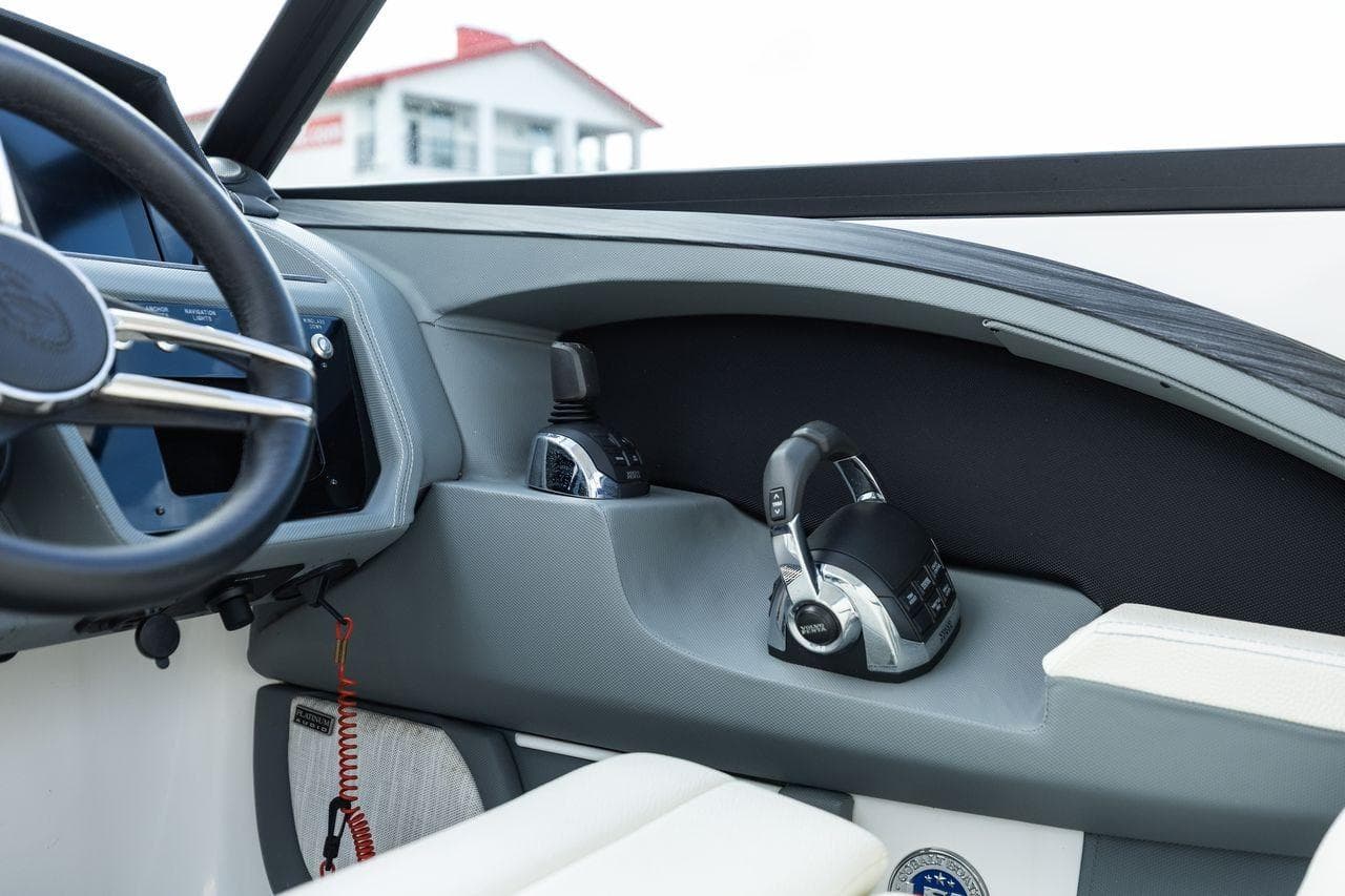 Interior view of a 2021 Cobalt R30 boat cockpit with steering wheel and controls.